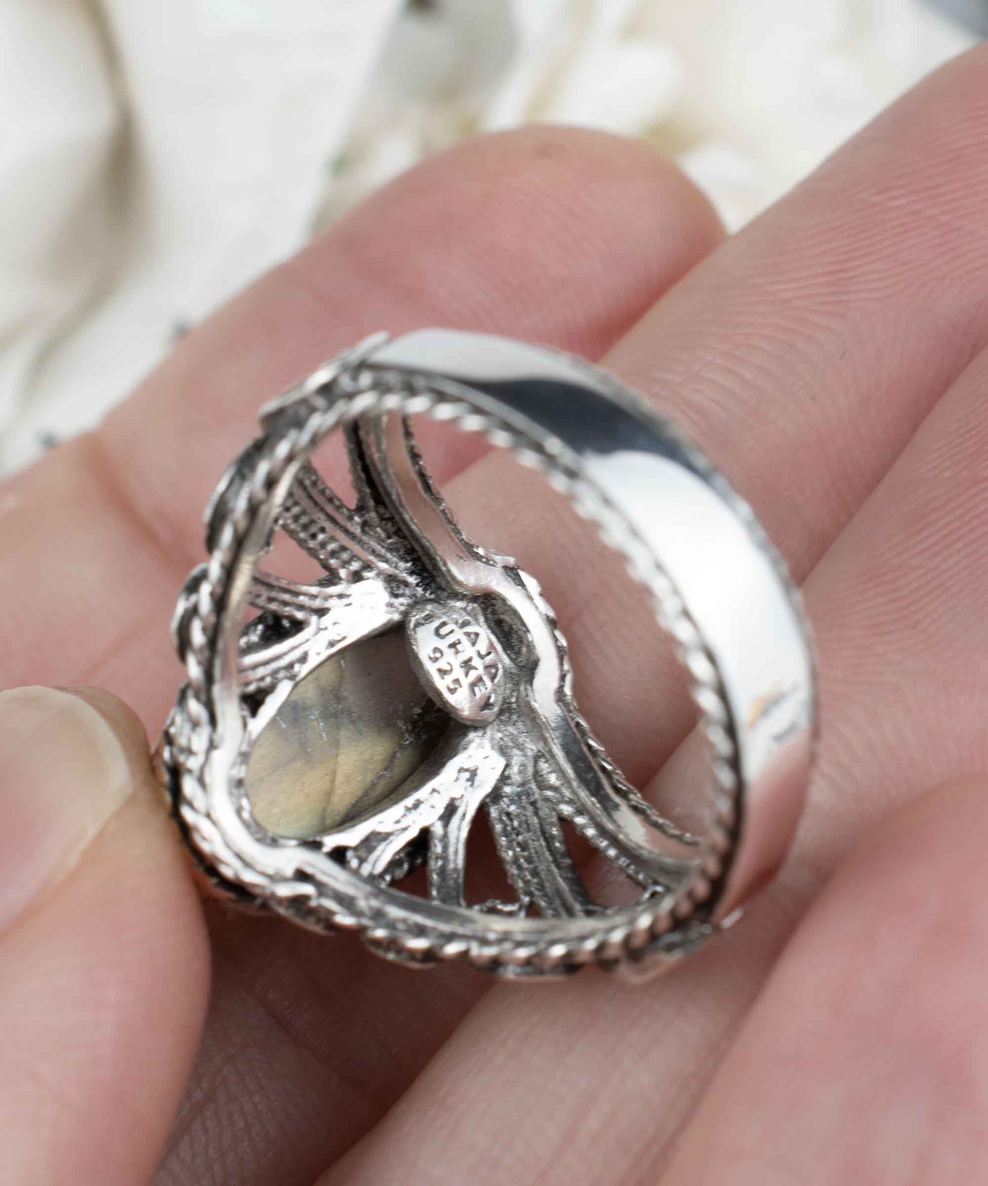 Elegant silver cocktail ring featuring a labradorite gemstone in an angel wings filigree design, crafted from 925 sterling silver.