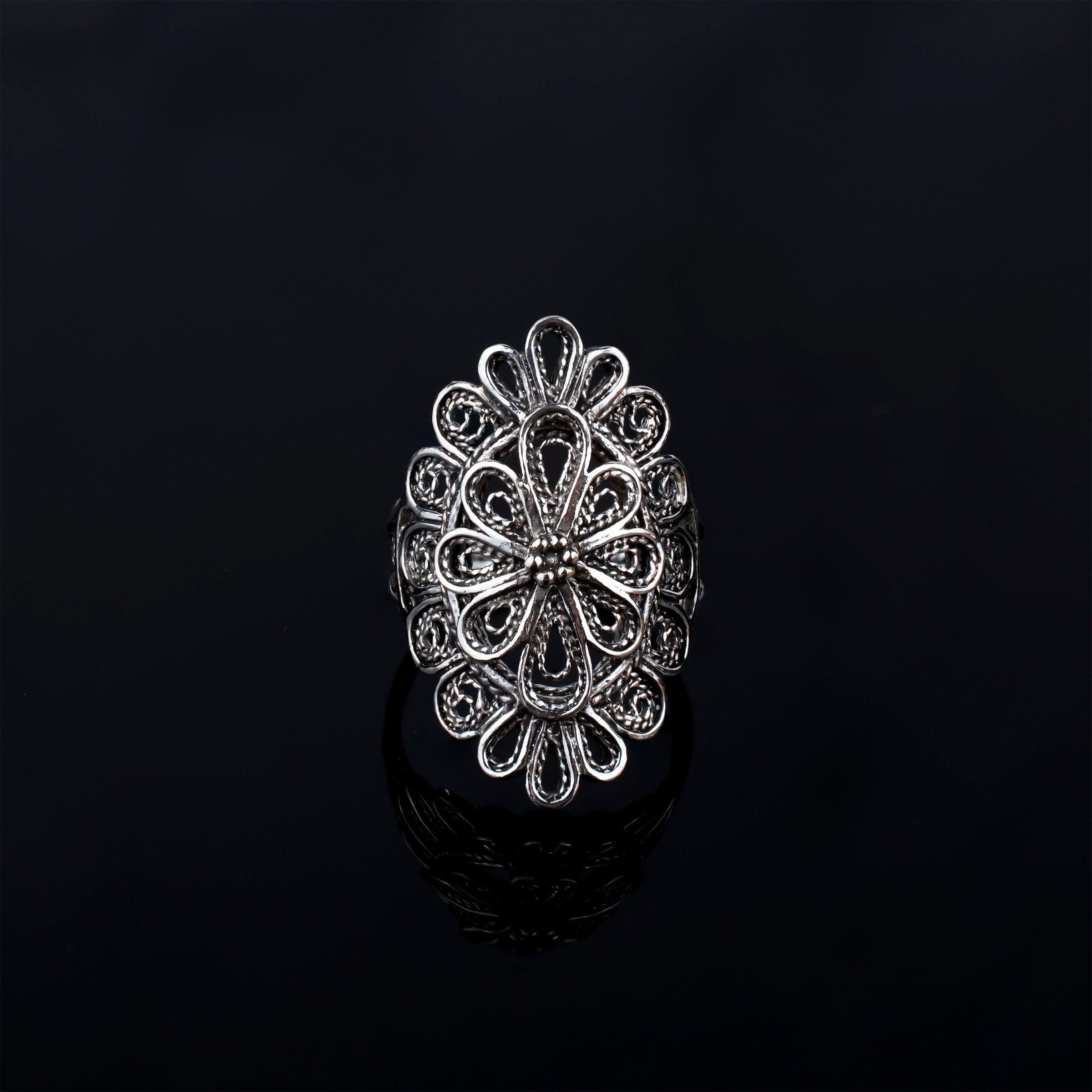 A stunning long statement ring made of sterling silver featuring intricate filigree lace detailing, showcasing a blend of traditional and modern artistry.