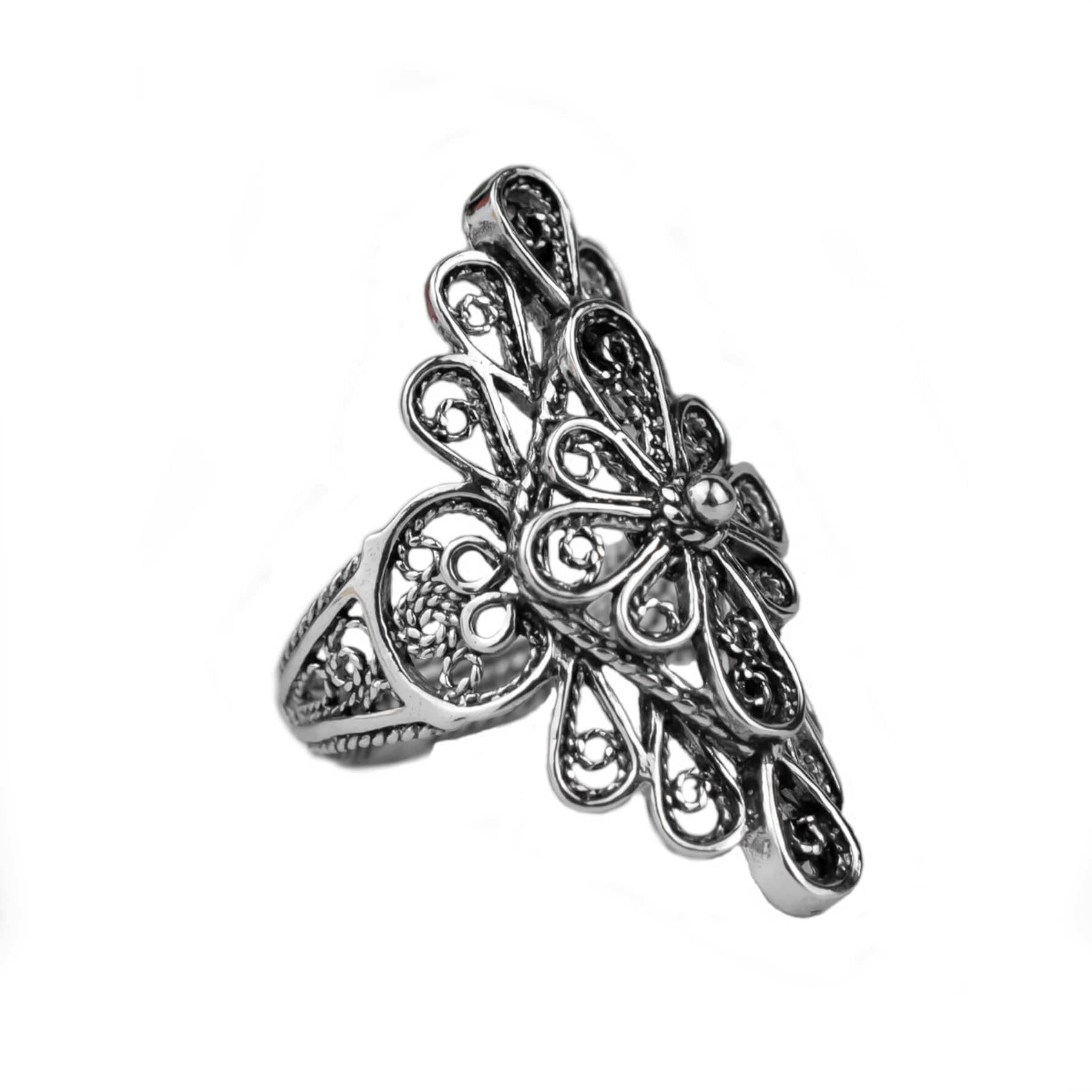 A stunning silver statement ring featuring intricate filigree lace embroidery, showcasing its elegant design and craftsmanship.
