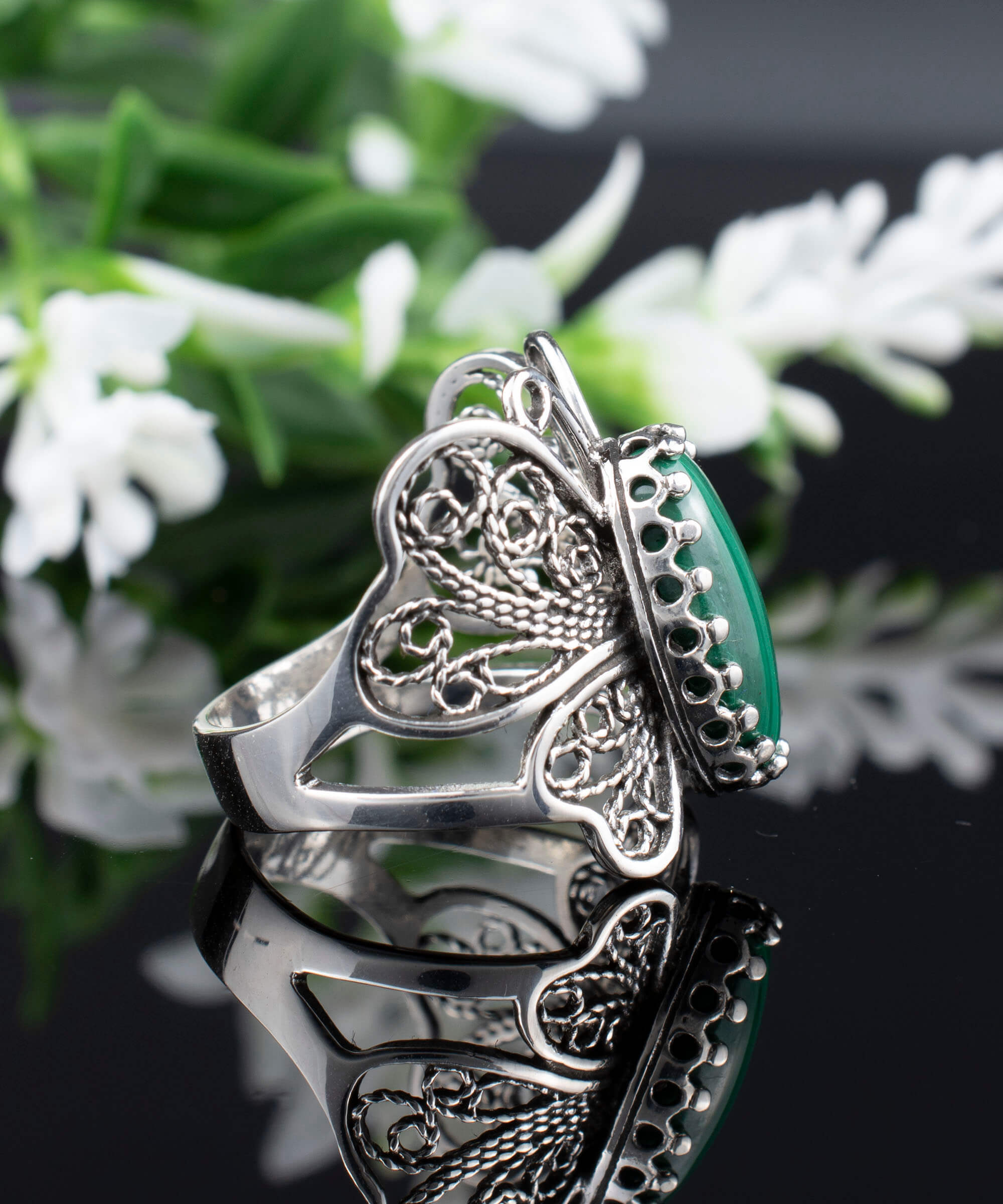 Sterling silver filigree butterfly cocktail ring featuring a malachite gemstone, elegantly designed with intricate details.