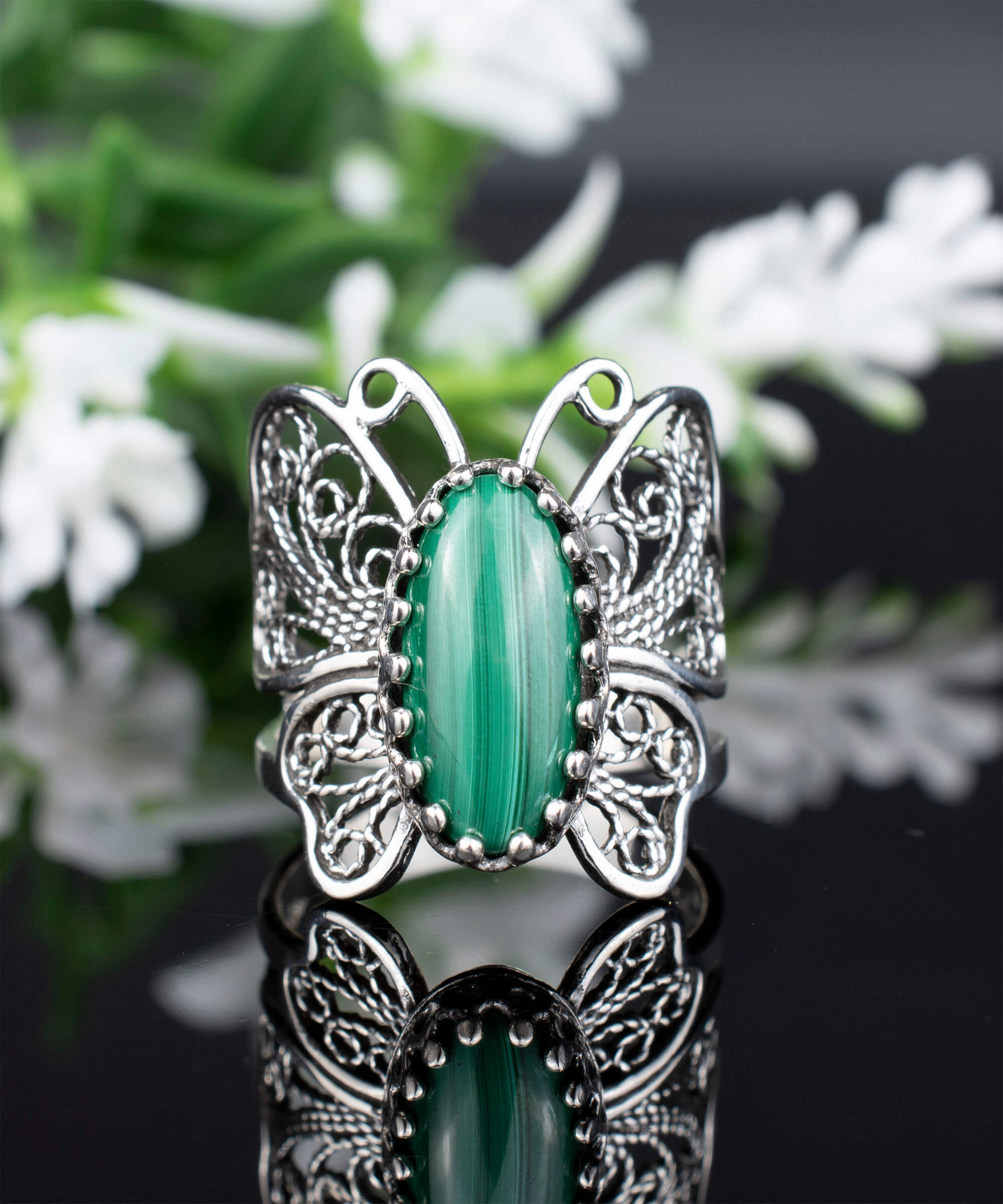 Sterling silver filigree butterfly cocktail ring featuring a malachite gemstone, elegantly designed with intricate details.
