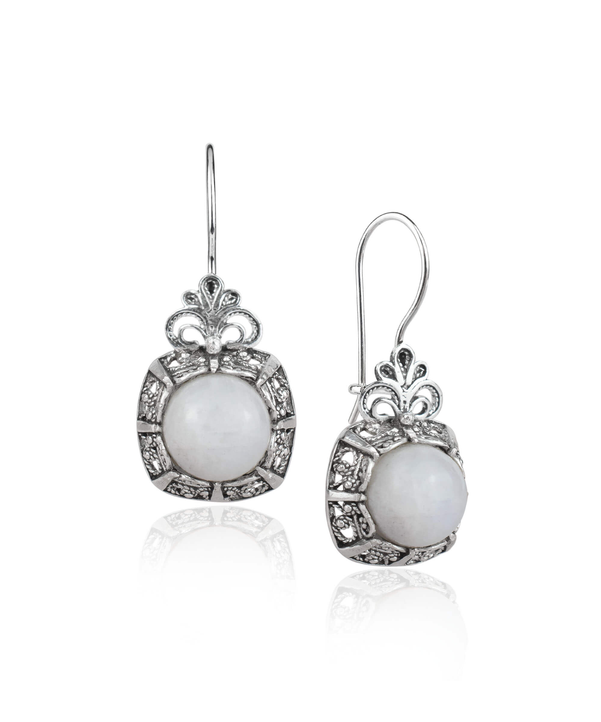 Elegant sterling silver drop earrings featuring a round-cut moonstone gemstone in a delicate filigree design.