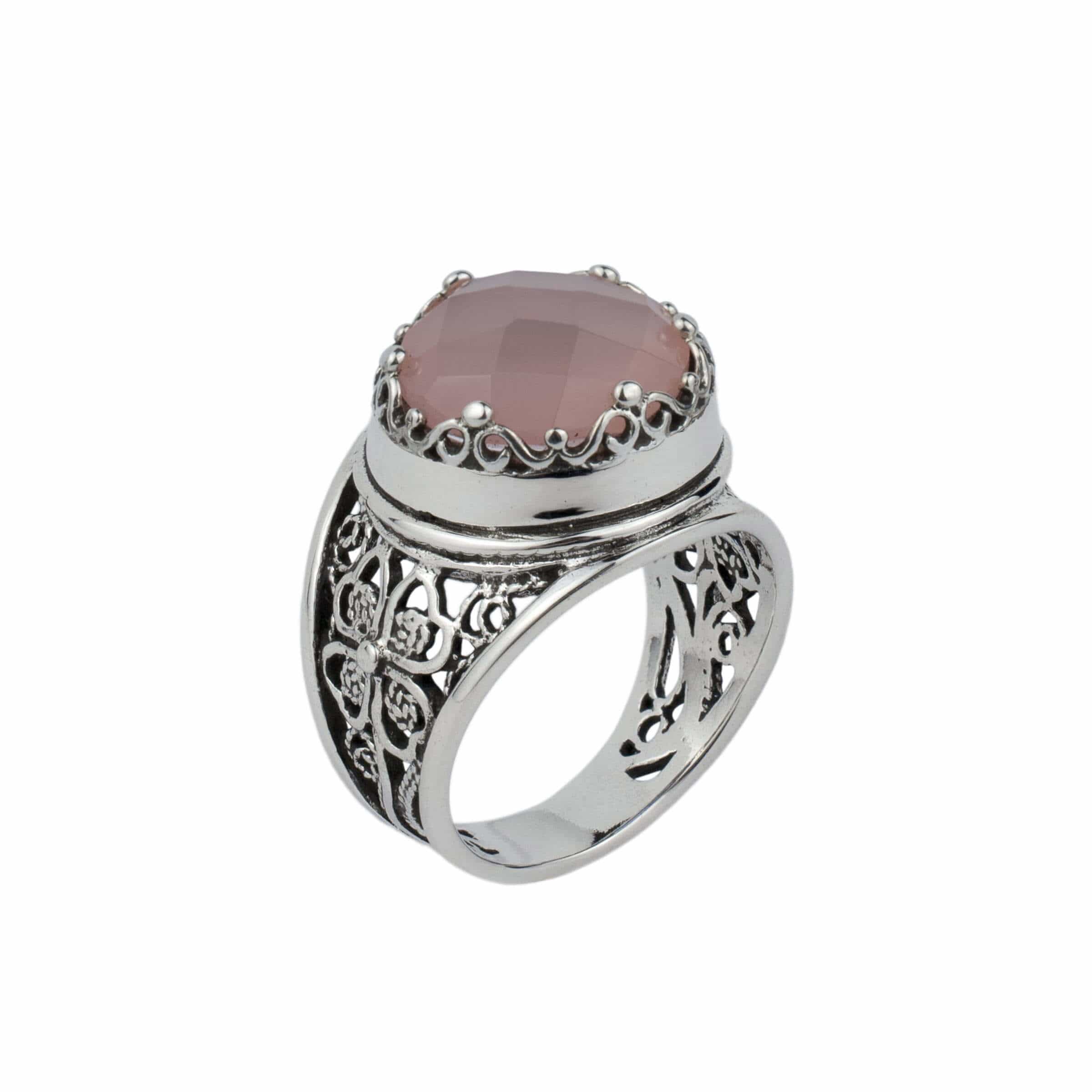 Sterling silver filigree art ring featuring a pink chalcedony gemstone, elegantly designed with intricate patterns.