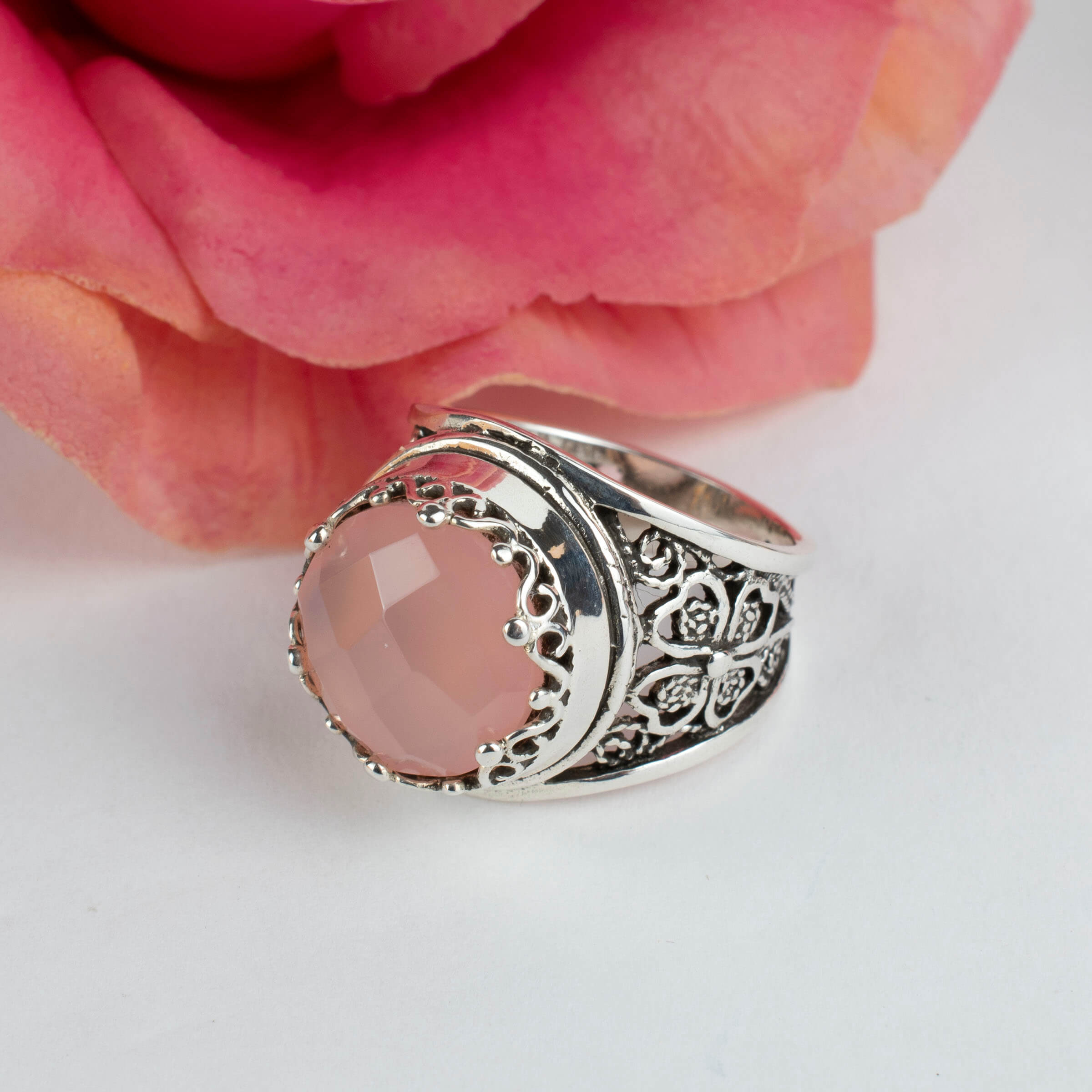 Sterling silver filigree art ring featuring a pink chalcedony gemstone, elegantly designed with intricate patterns.