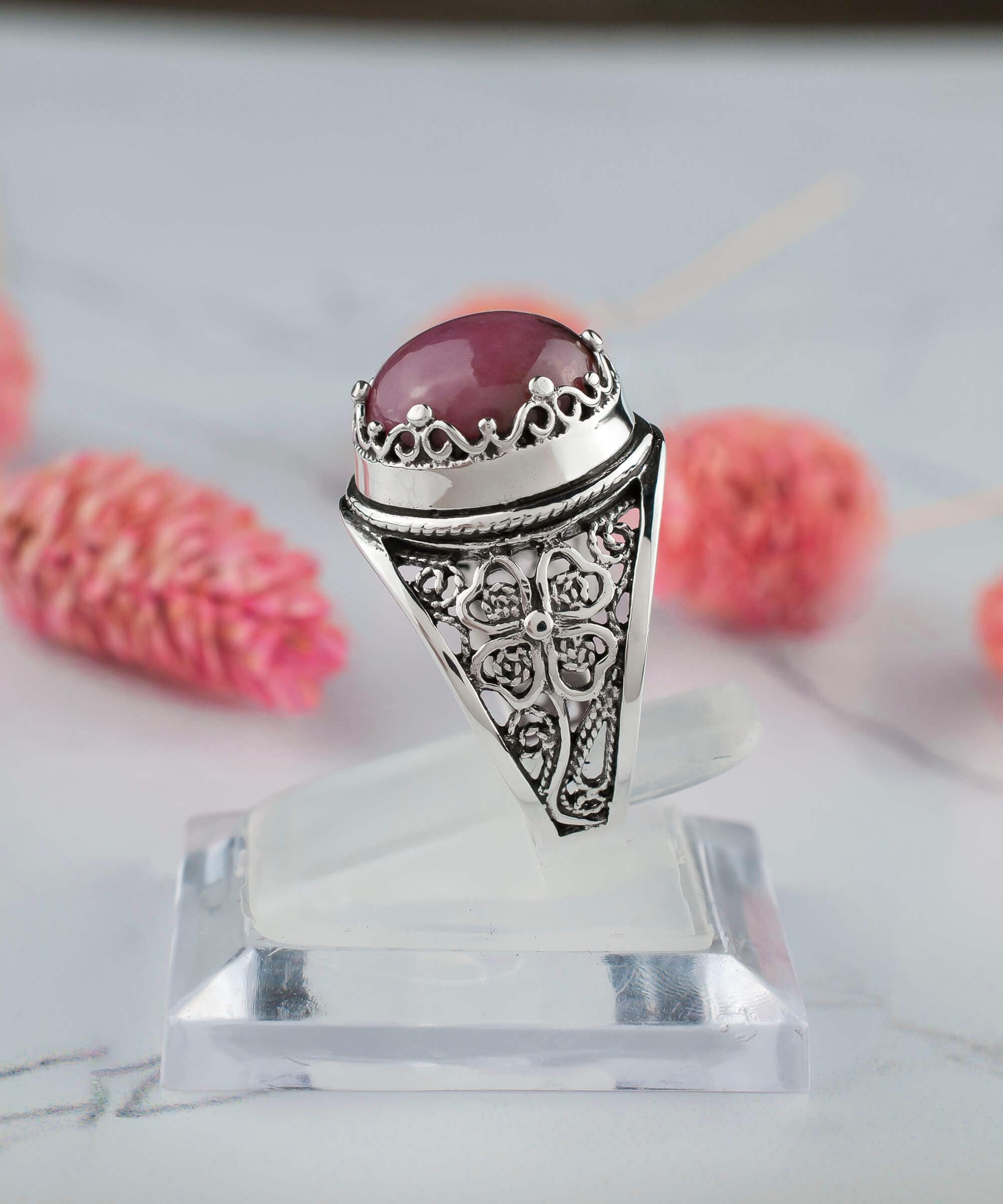 A stunning sterling silver filigree ring featuring a round cut rhodonite gemstone, elegantly designed for women.