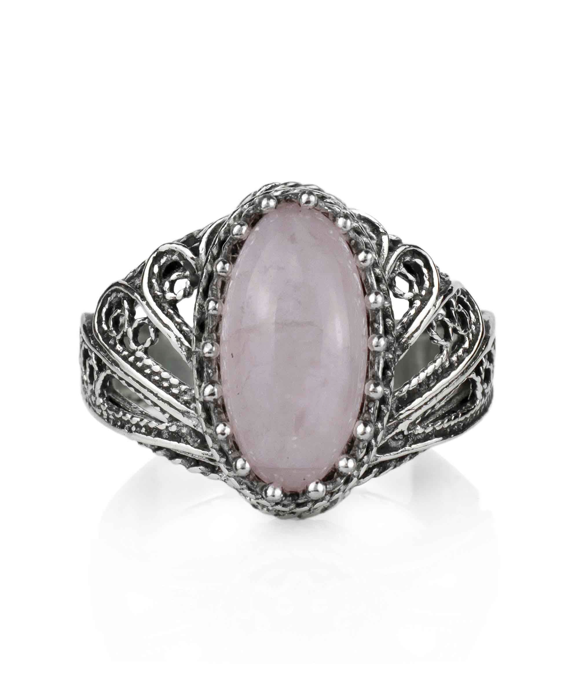 Elegant silver cocktail ring featuring intricate filigree design and a rose quartz gemstone in angel wings setting.