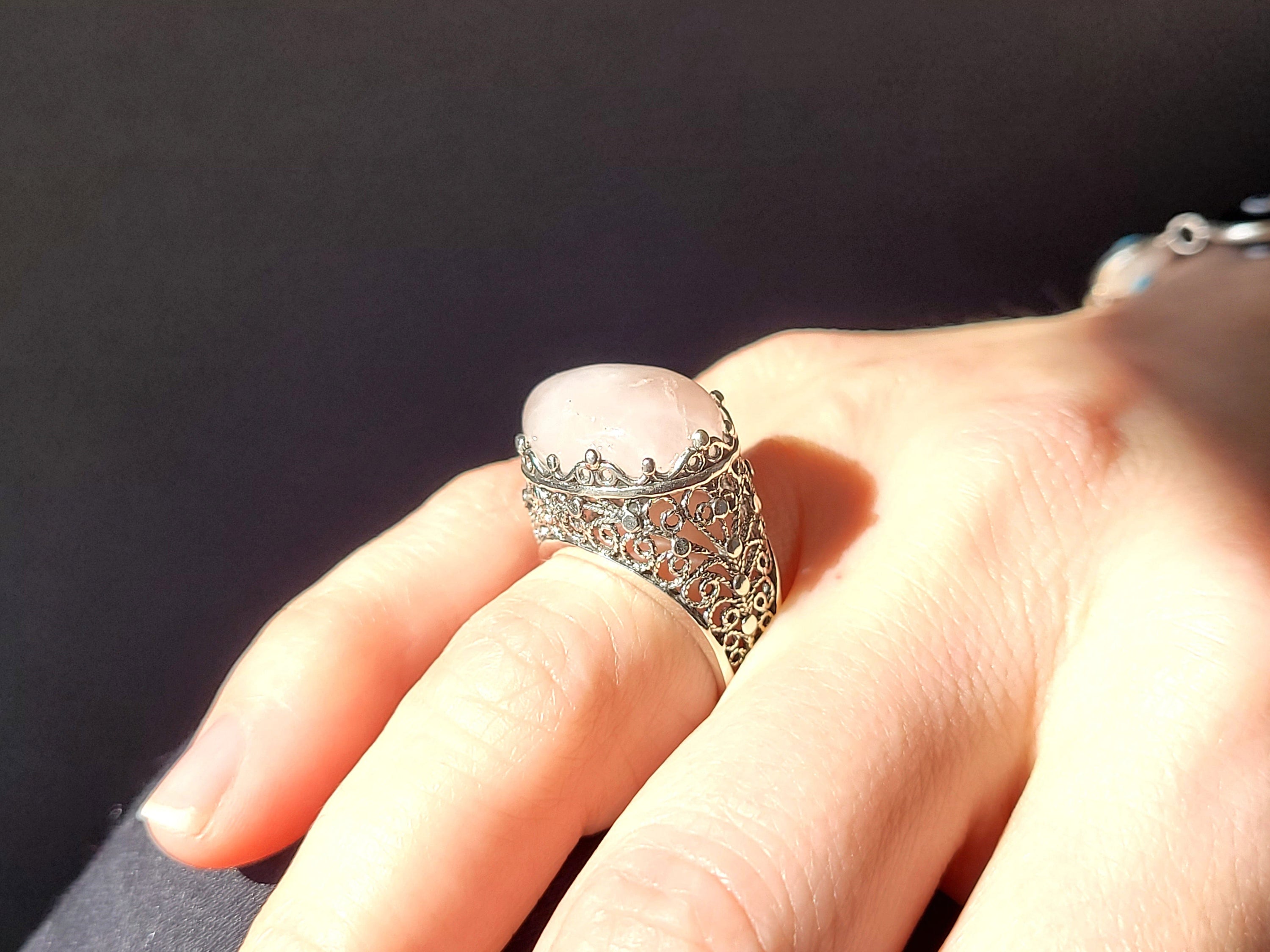 A beautifully crafted silver dome statement ring featuring a pink rose quartz gemstone set in intricate filigree art design.