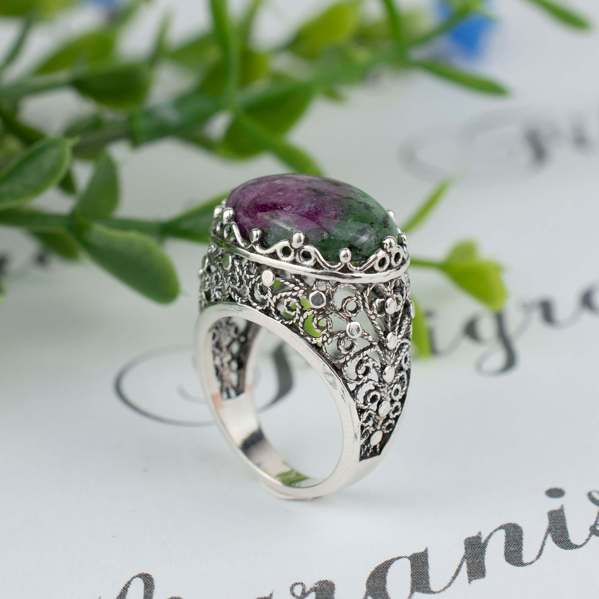 Handmade silver dome statement ring featuring a stunning ruby zoisite gemstone with intricate filigree design.
