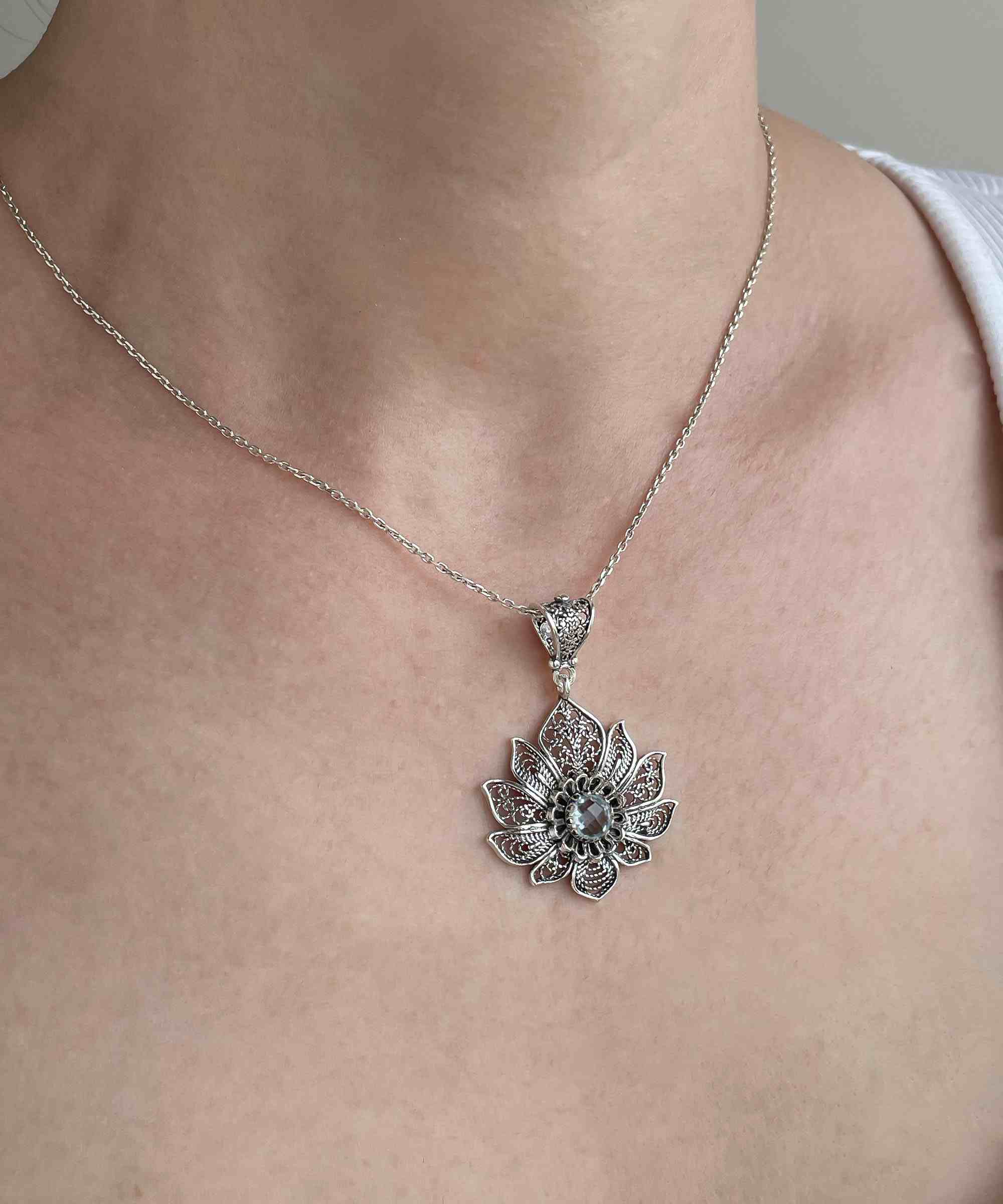 Handcrafted 925 Sterling Silver Lotus Flower Pendant with Blue Topaz gemstone, showcasing intricate filigree design.
