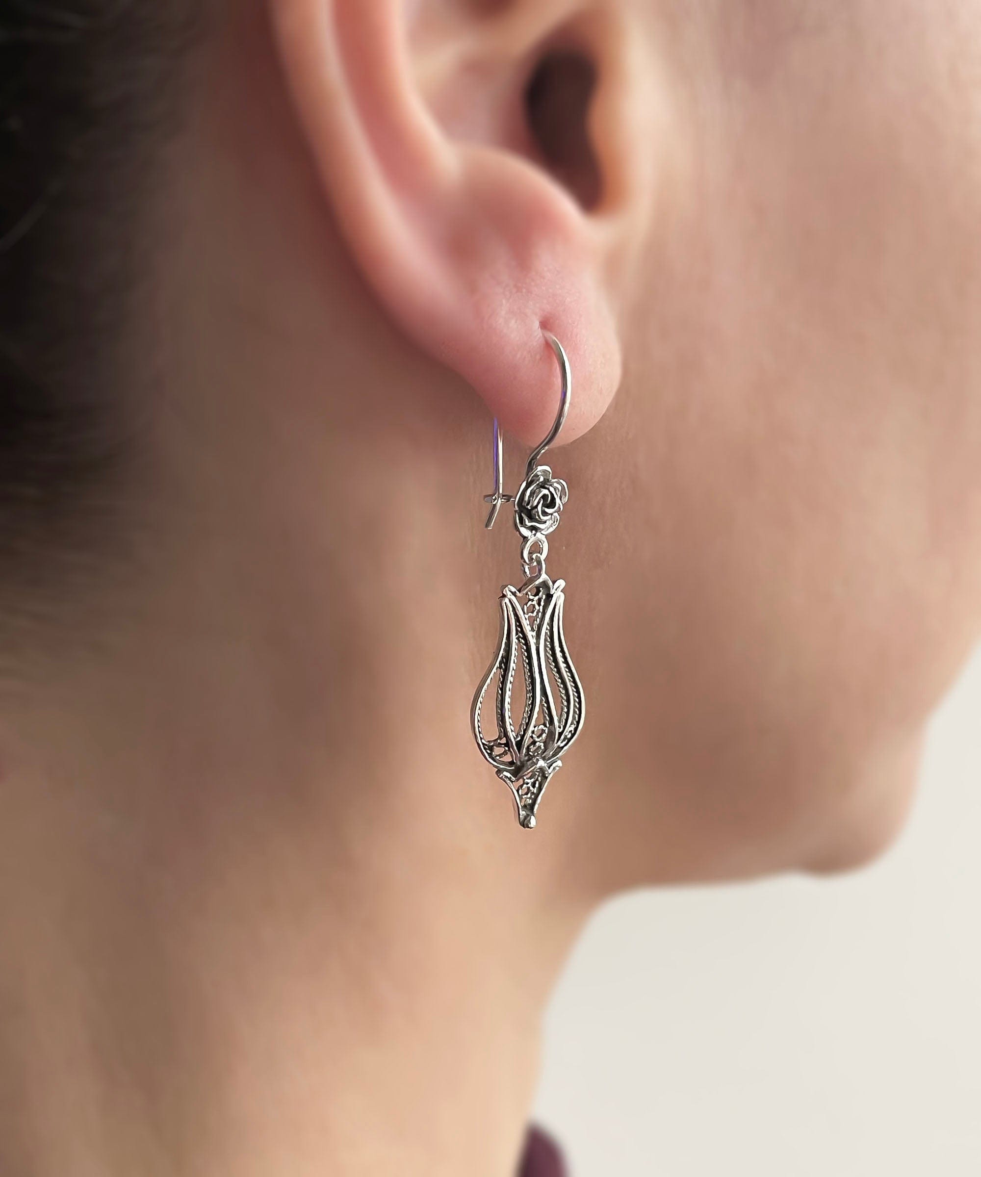 Elegant handmade sterling silver dangle drop earrings featuring a tulip design with intricate filigree detailing.