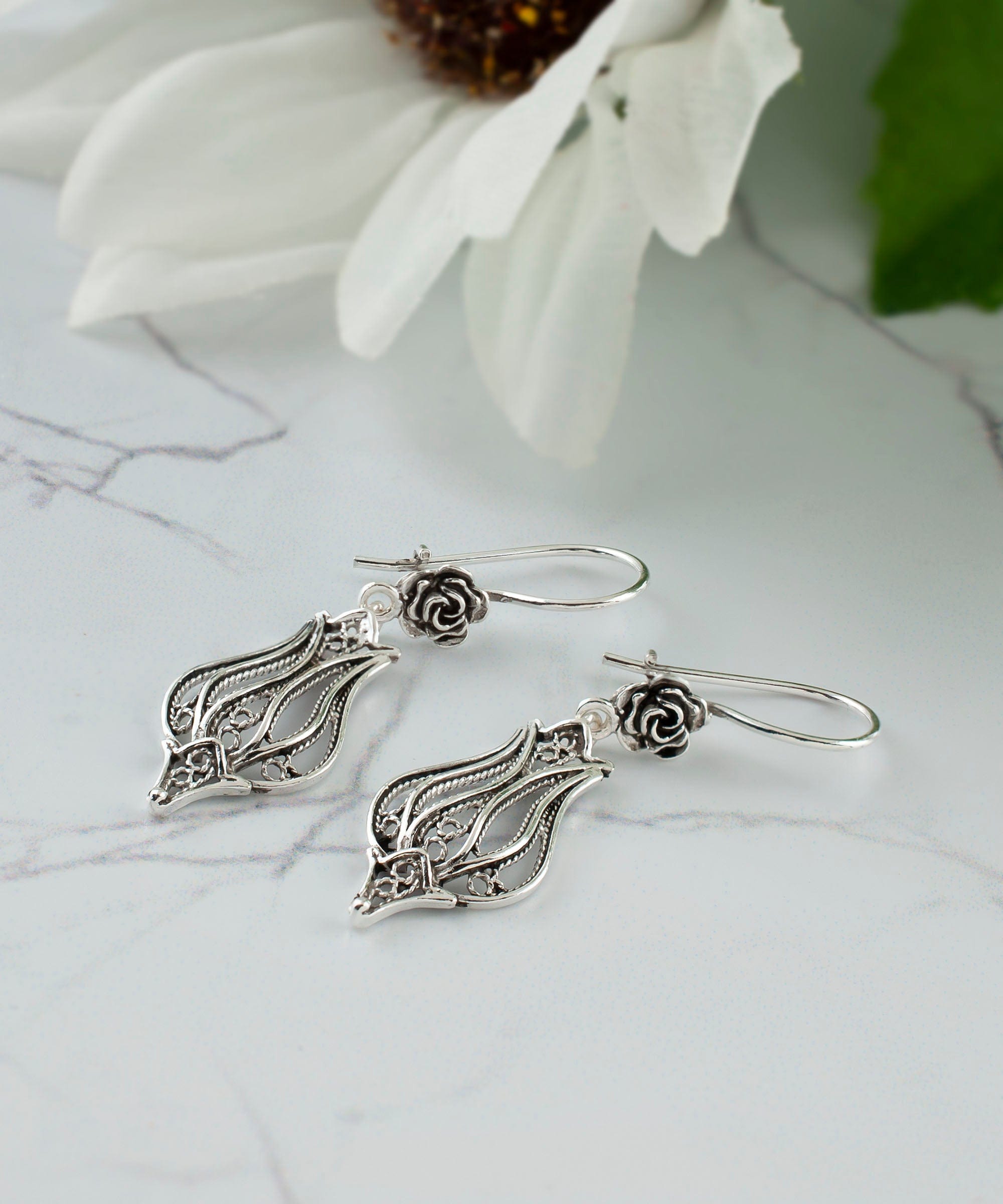 Elegant handmade sterling silver dangle drop earrings featuring a tulip design with intricate filigree detailing.