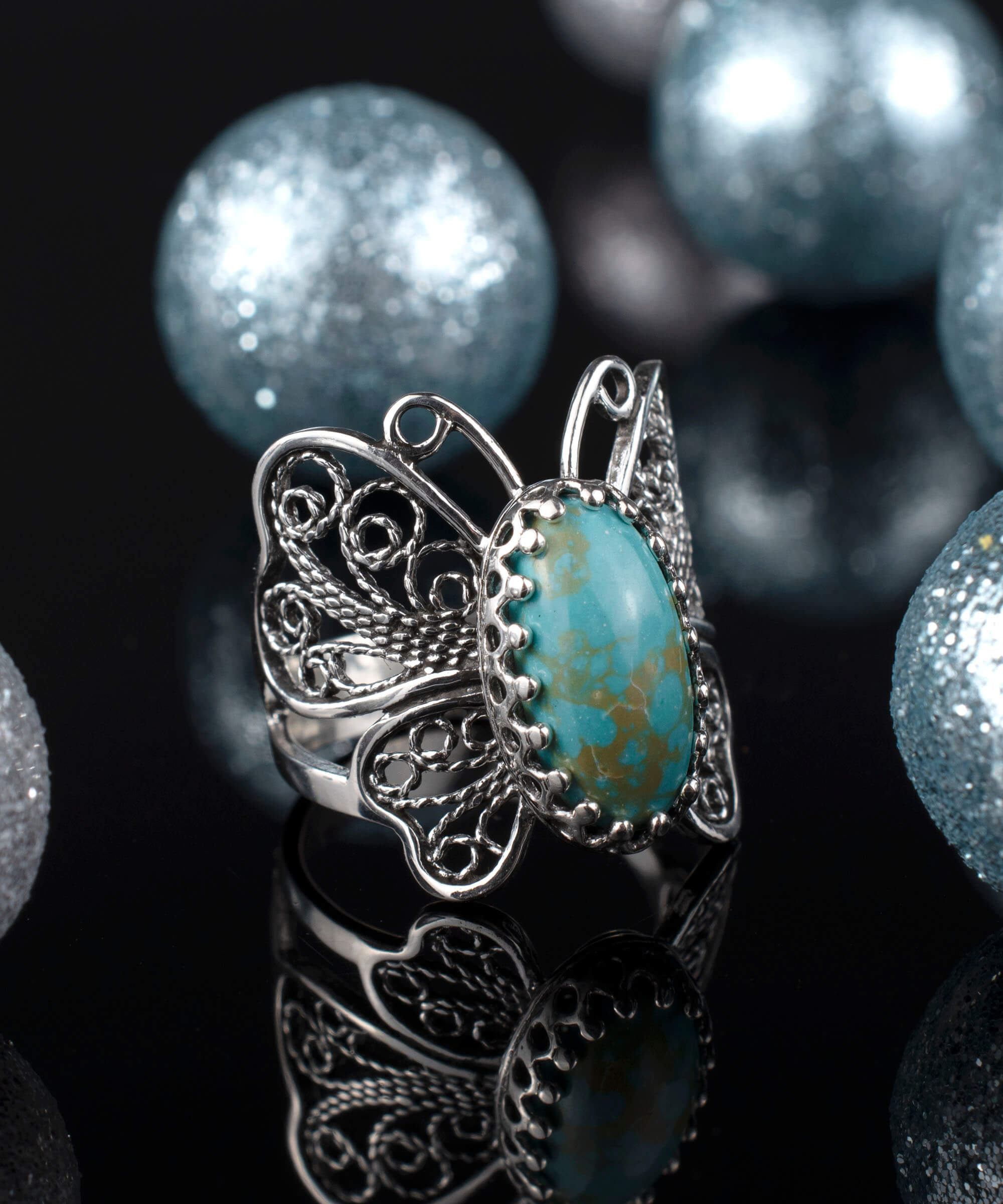 Sterling silver filigree butterfly cocktail ring featuring a turquoise gemstone, elegantly designed for women.