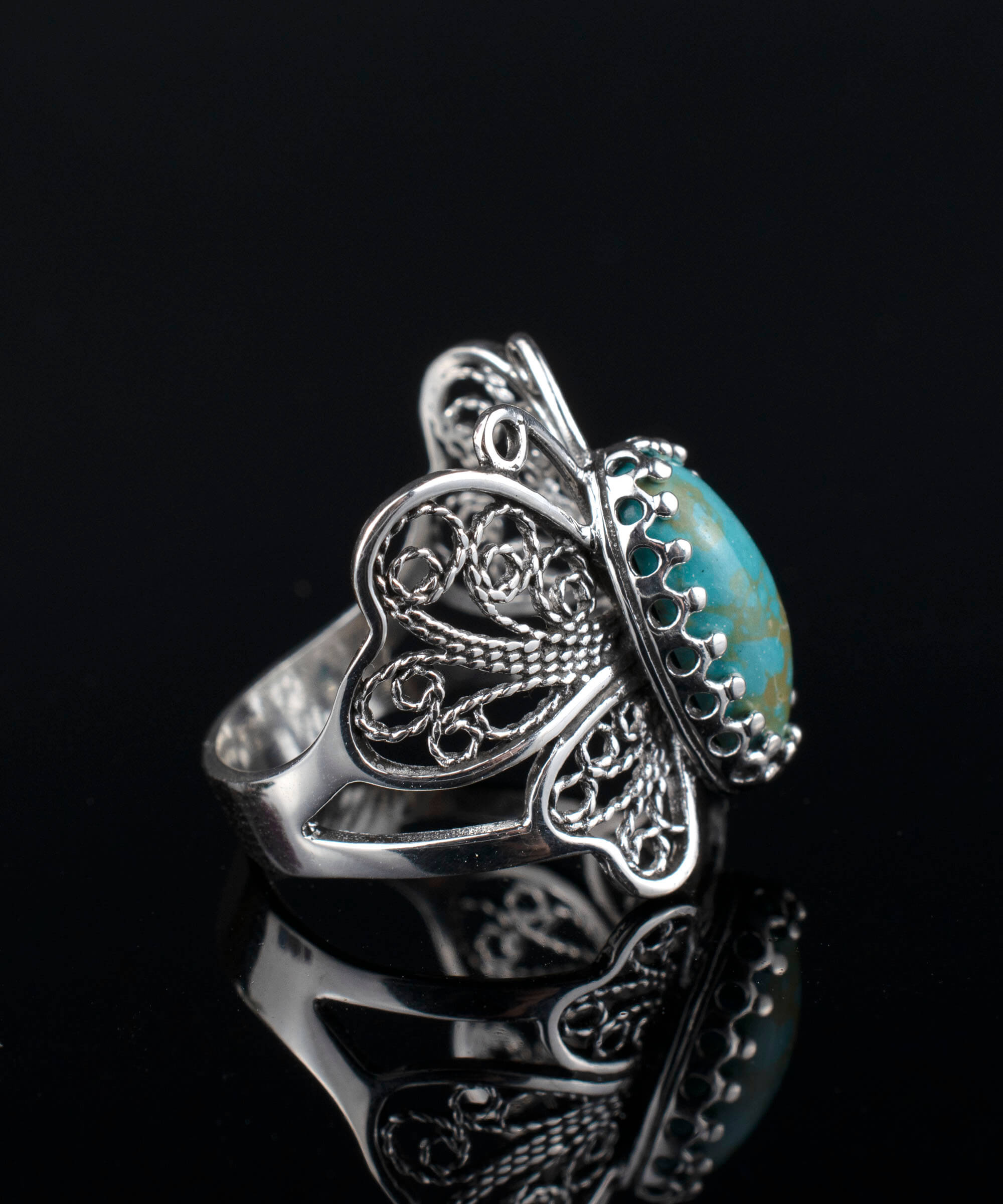 Sterling silver filigree butterfly cocktail ring featuring a turquoise gemstone, elegantly designed for women.