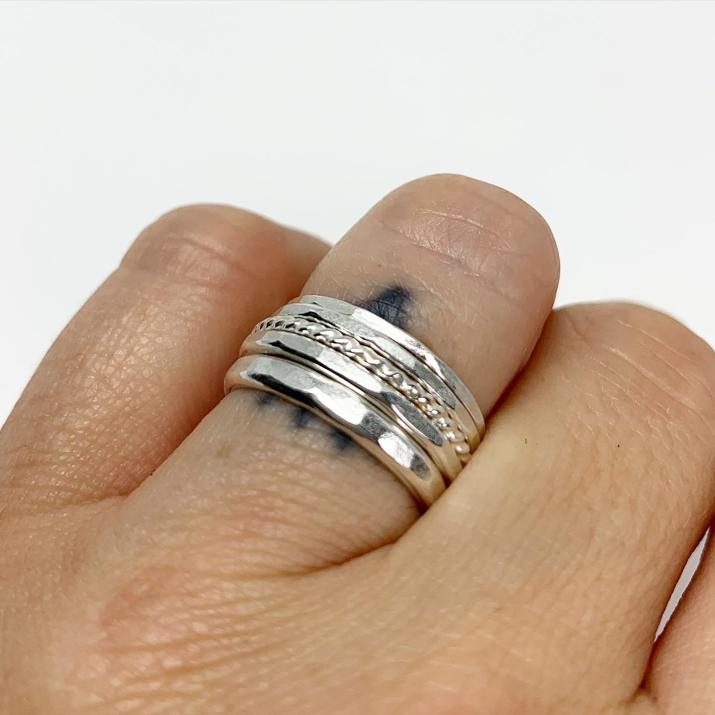 Bridal Stacking Ring Set featuring five textured rings with hammered and twisted designs, handmade from recycled metals.