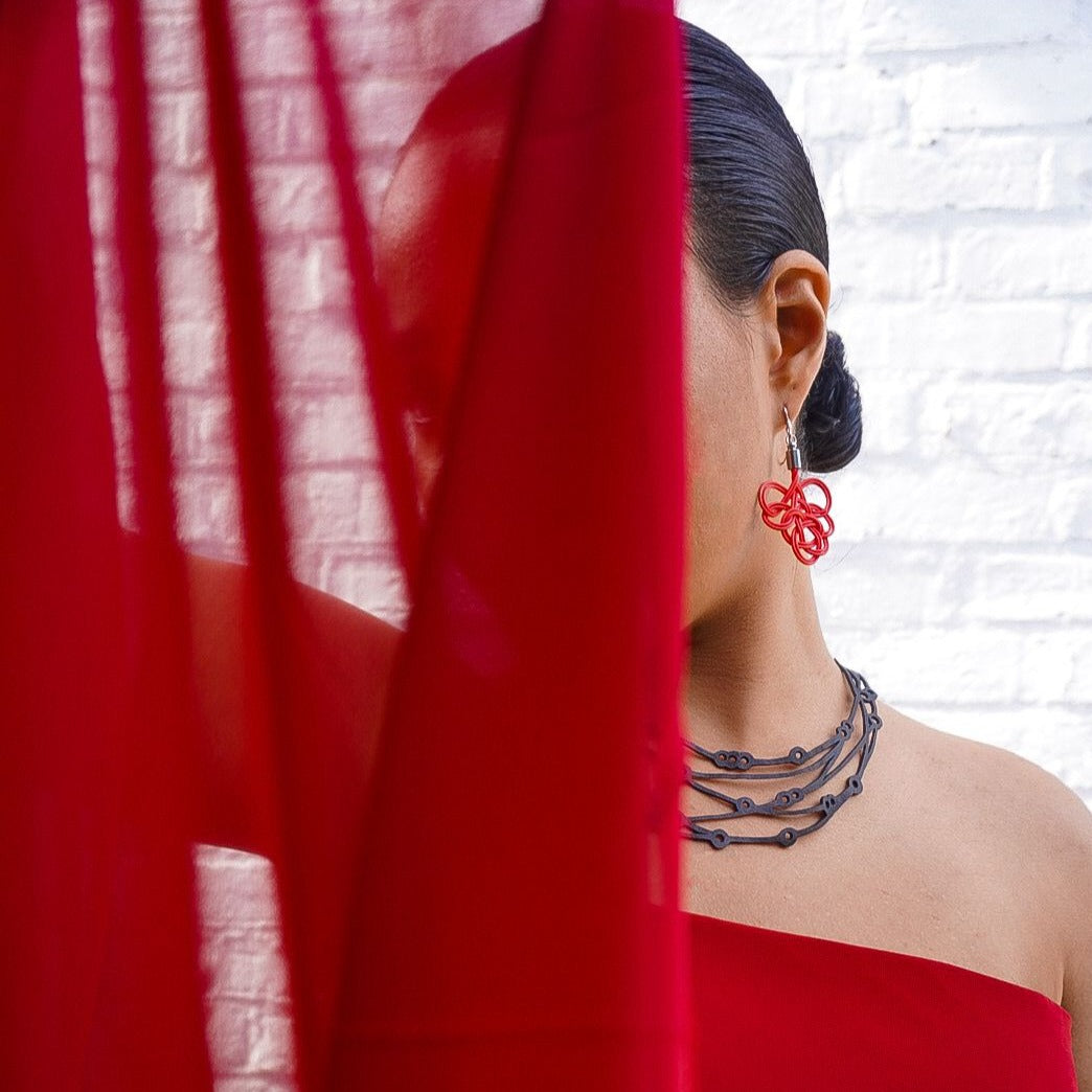 Flare Reclaimed Rubber Necklace made from recycled tyre inner tubes, featuring a multi-strap design and a button snap fastener.