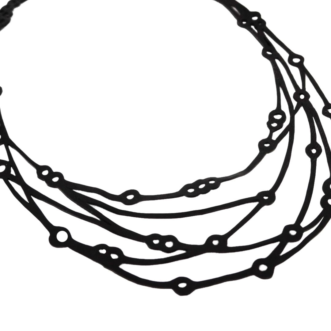 Flare Reclaimed Rubber Necklace made from recycled tyre inner tubes, featuring a multi-strap design and a button snap fastener.