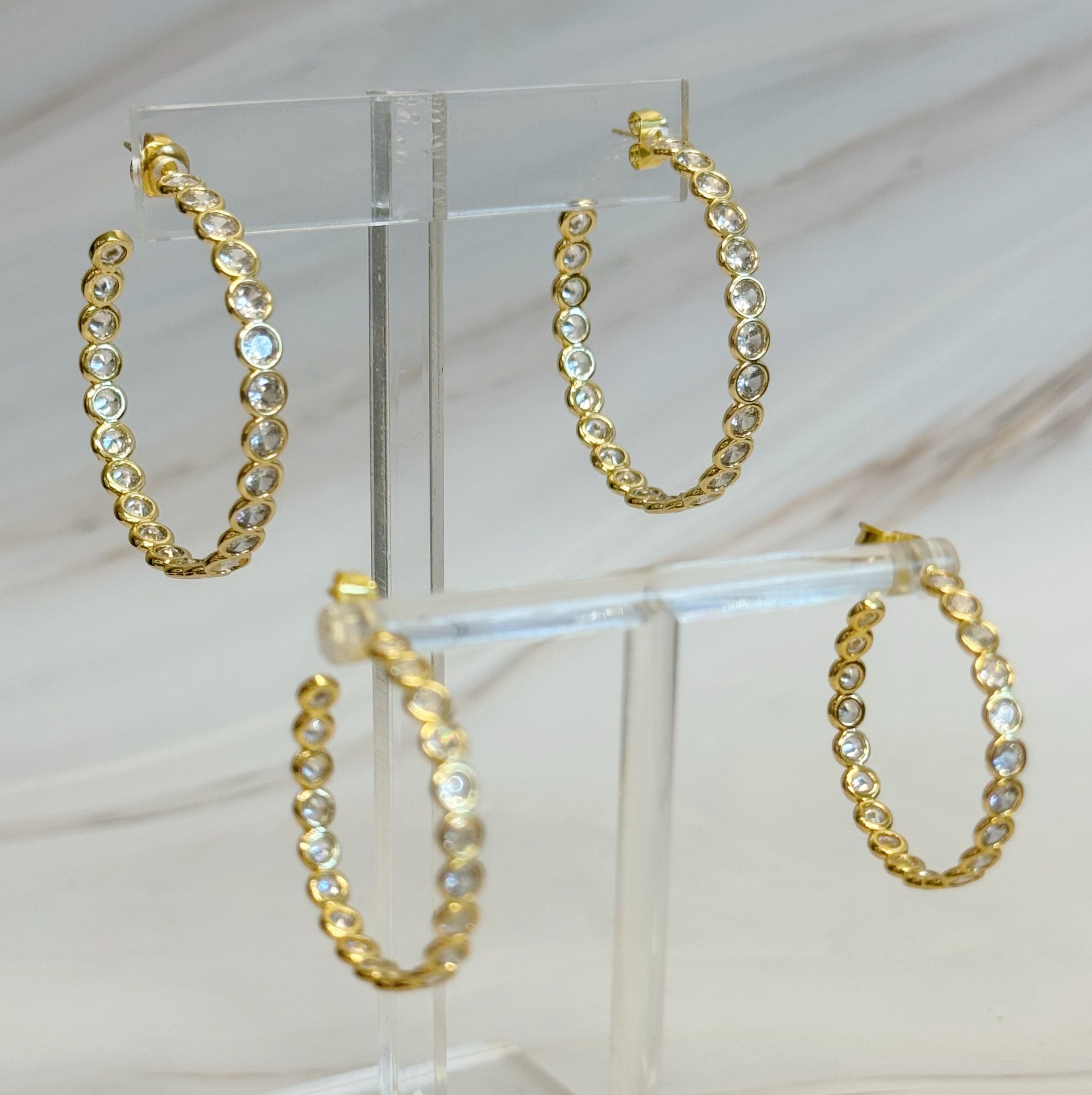Elegant Floating Bezel Crystal Hoop Earrings with sparkling cubic zirconia set in 18K gold plated brass, showcasing a stylish design.