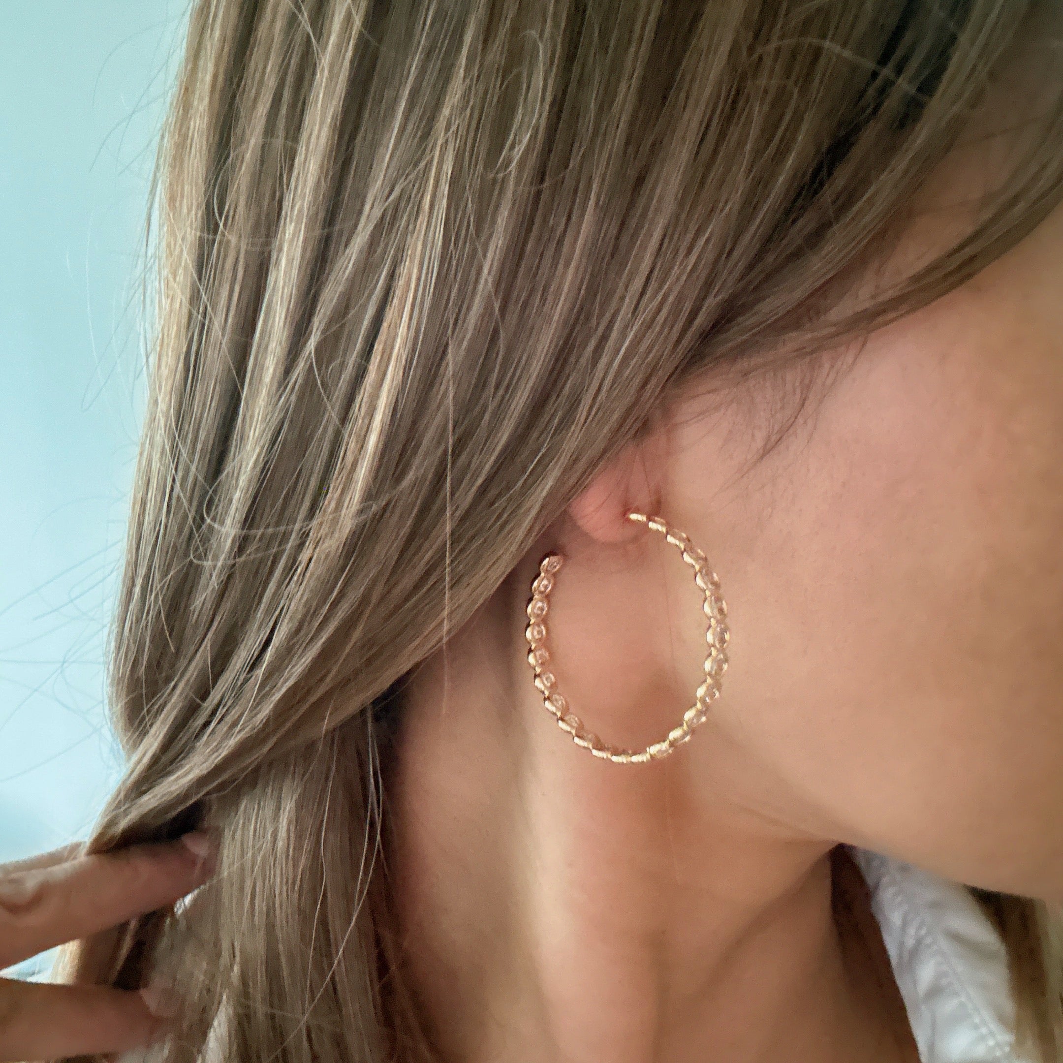 Elegant Floating Bezel Crystal Hoop Earrings with sparkling cubic zirconia set in 18K gold plated brass, showcasing a stylish design.