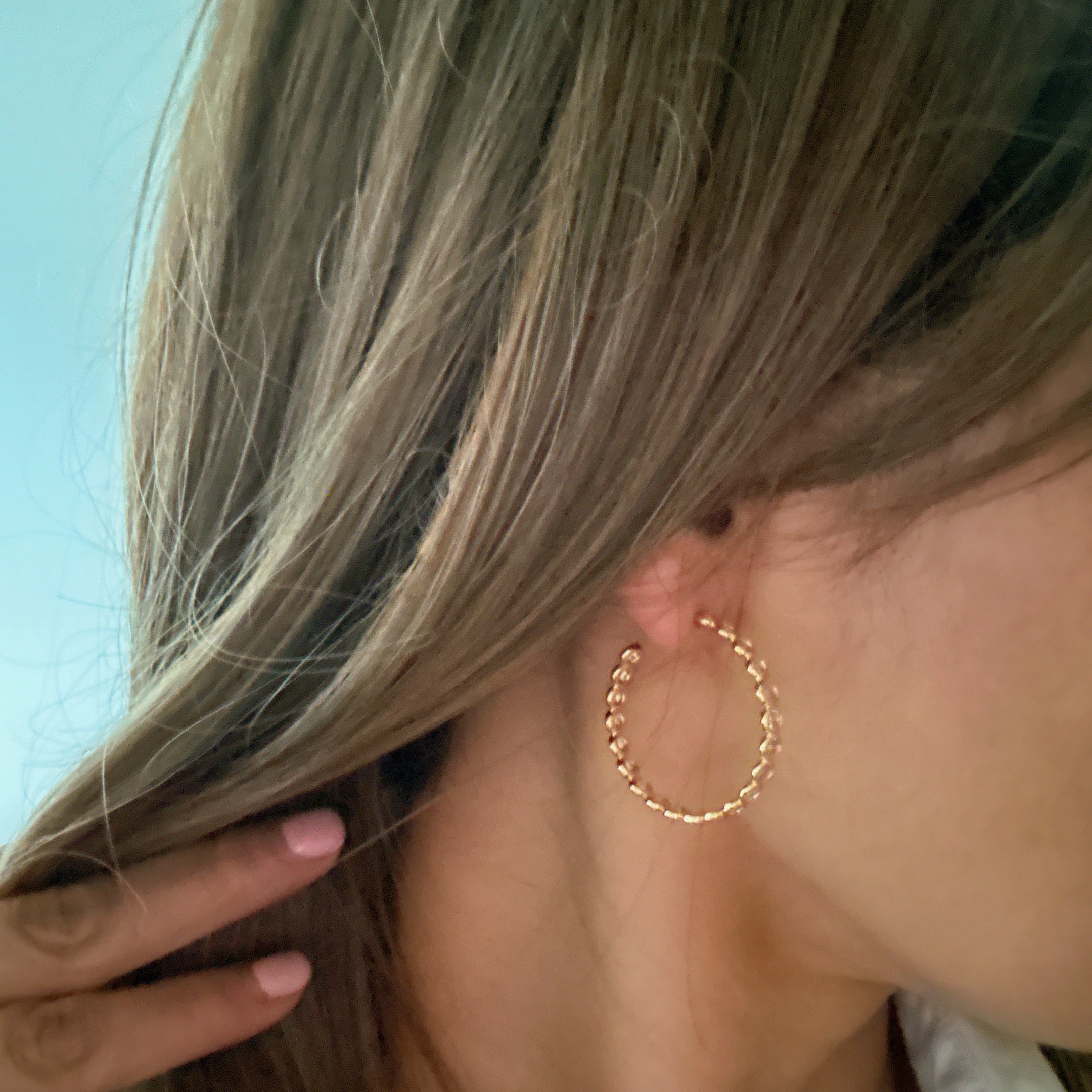 Elegant Floating Bezel Crystal Hoop Earrings with sparkling cubic zirconia set in 18K gold plated brass, showcasing a stylish design.