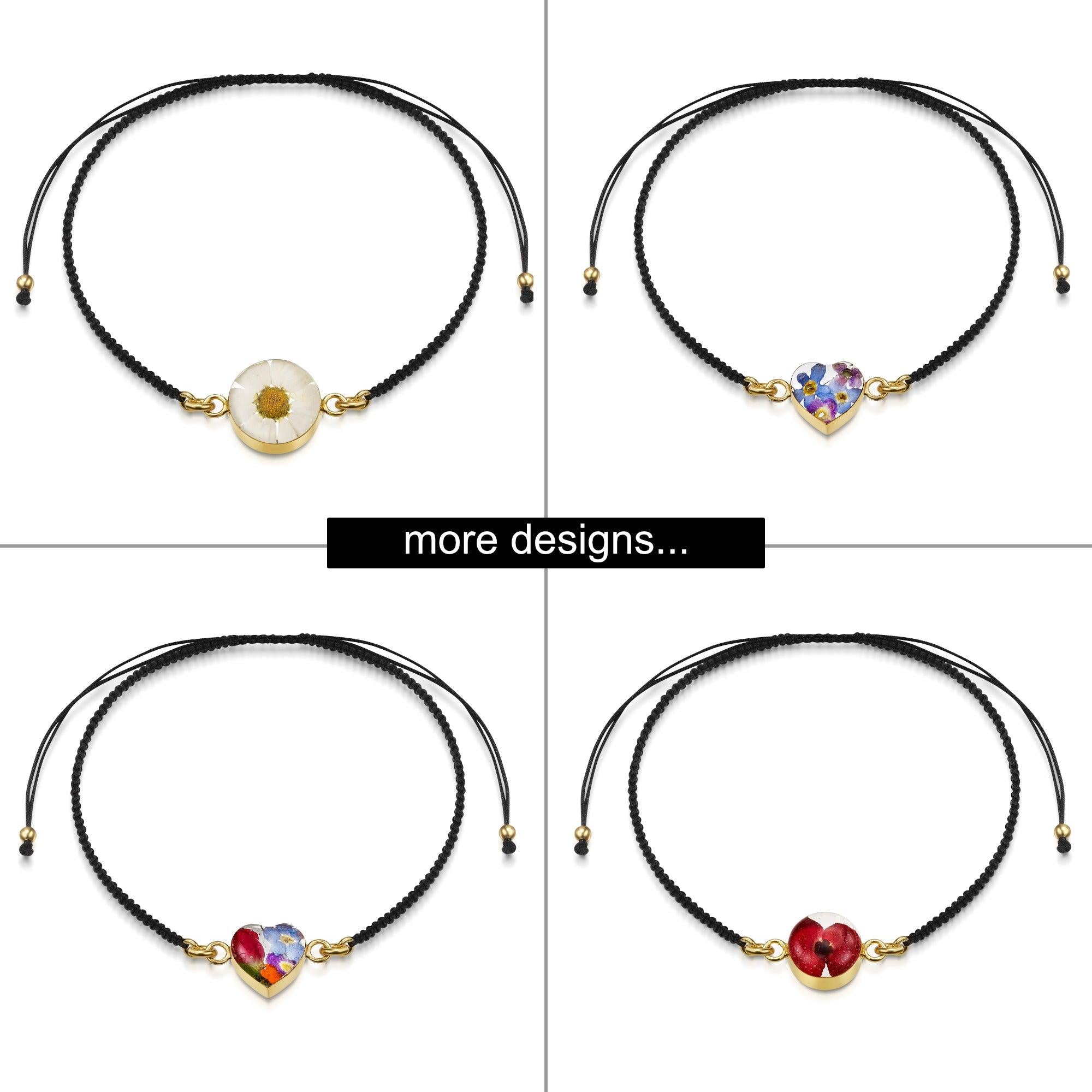 Black woven bracelet featuring a gold-plated flower charm, elegantly designed for stylish wear.