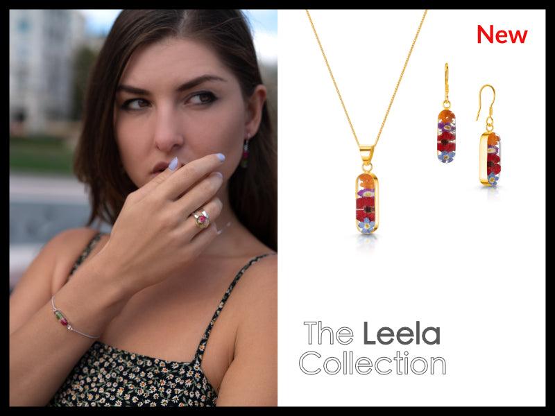 Elegant Flower Necklace by Shrieking Violet® featuring a vertical bar pendant filled with real dried flowers, on a sterling silver chain.