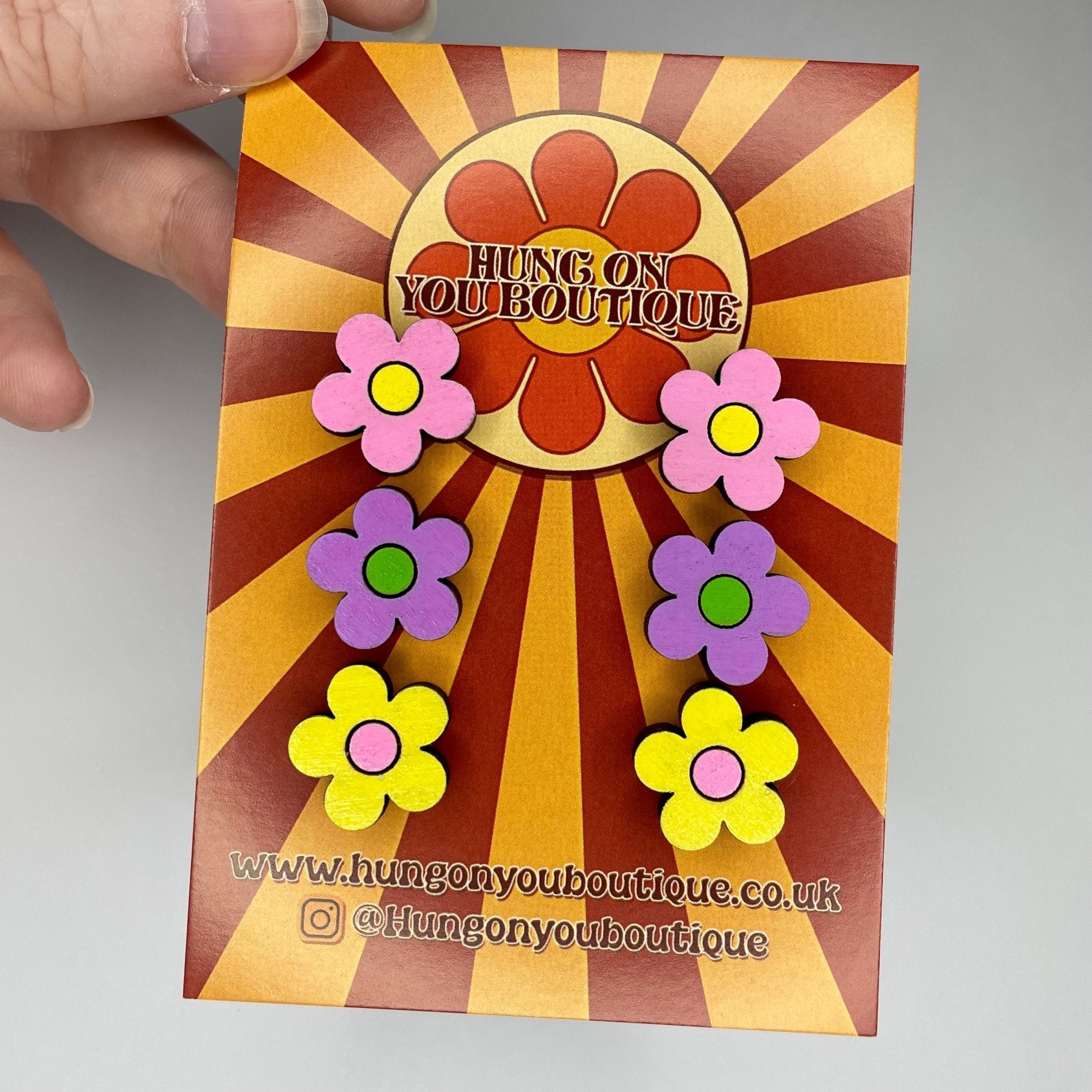 A vibrant collection of Flower Studs 3 Pack featuring colorful flower designs made from sustainable Birch Plywood.