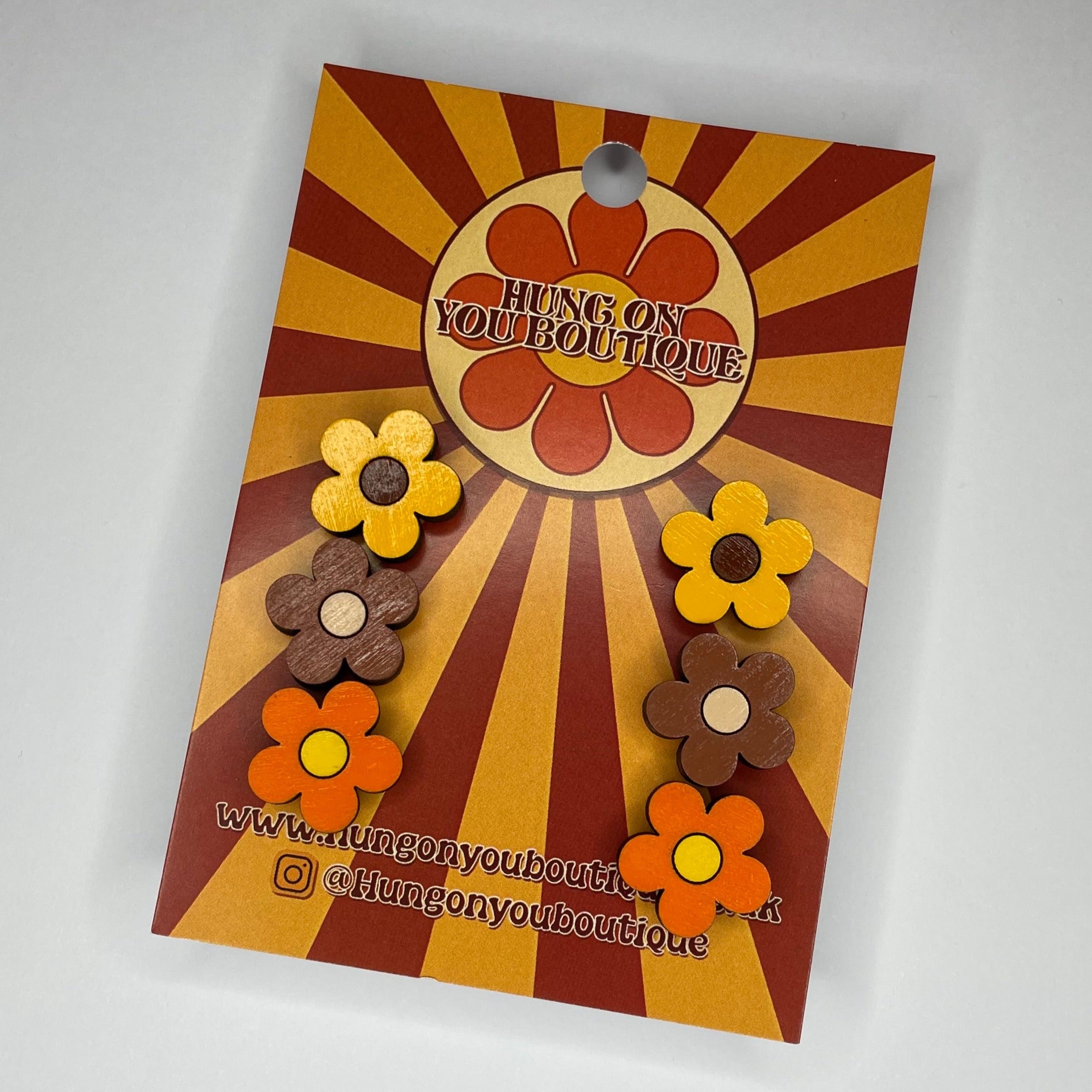 A vibrant collection of Flower Studs 3 Pack featuring colorful flower designs made from sustainable Birch Plywood.