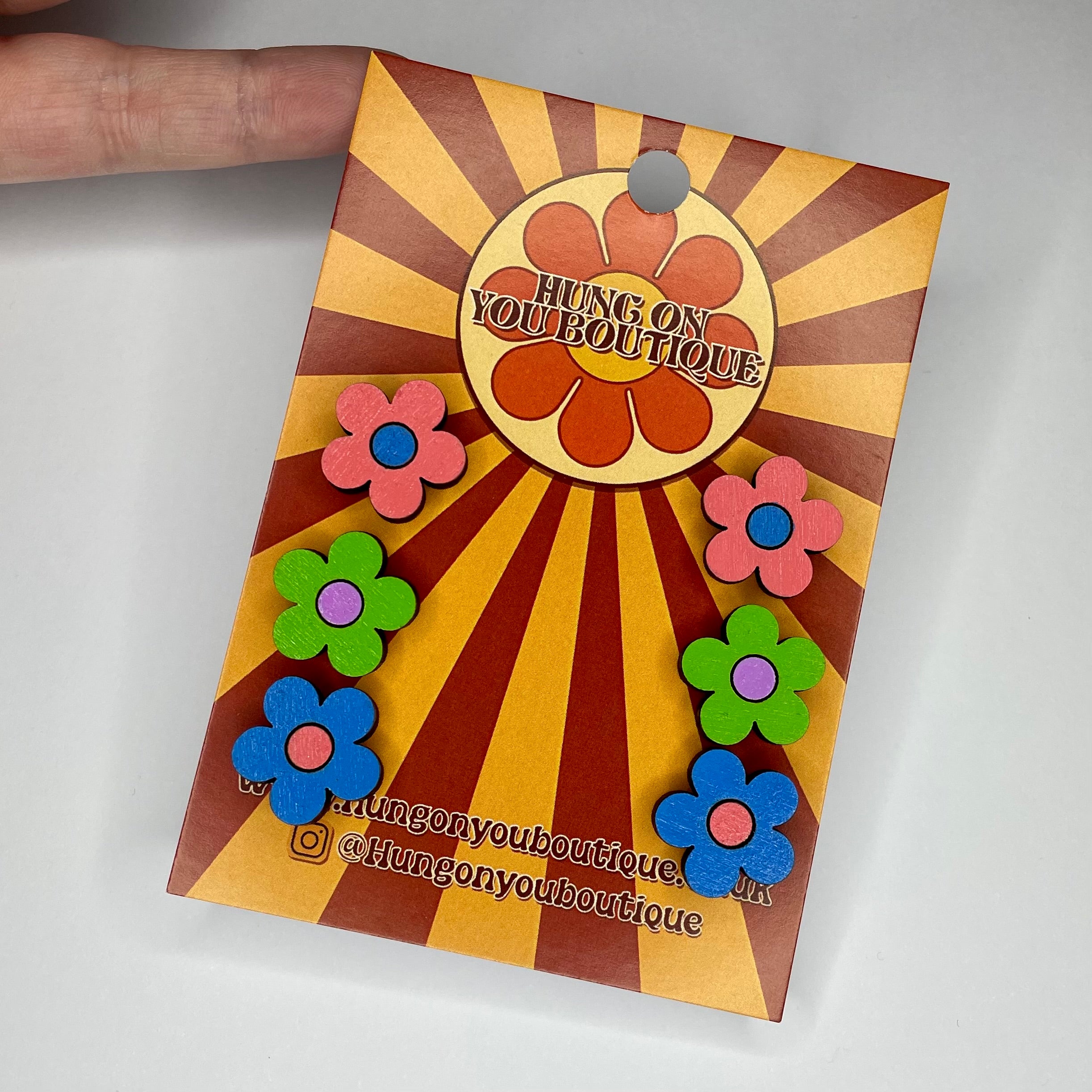 A vibrant collection of Flower Studs 3 Pack featuring colorful flower designs made from sustainable Birch Plywood.