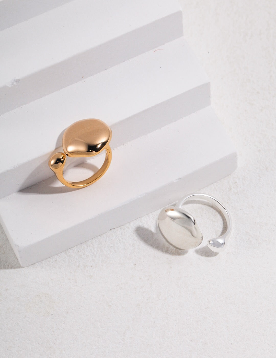 Fluid Elegance Water Droplet-inspired Ring made of sterling silver and gold vermeil, showcasing a unique droplet design.