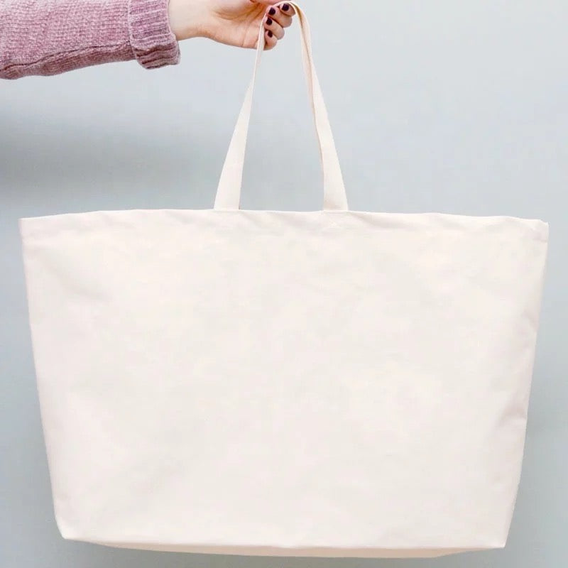 For Everything Canvas Tote featuring a spacious design and stylish 'EVERYTHING' font, perfect for summer outings.
