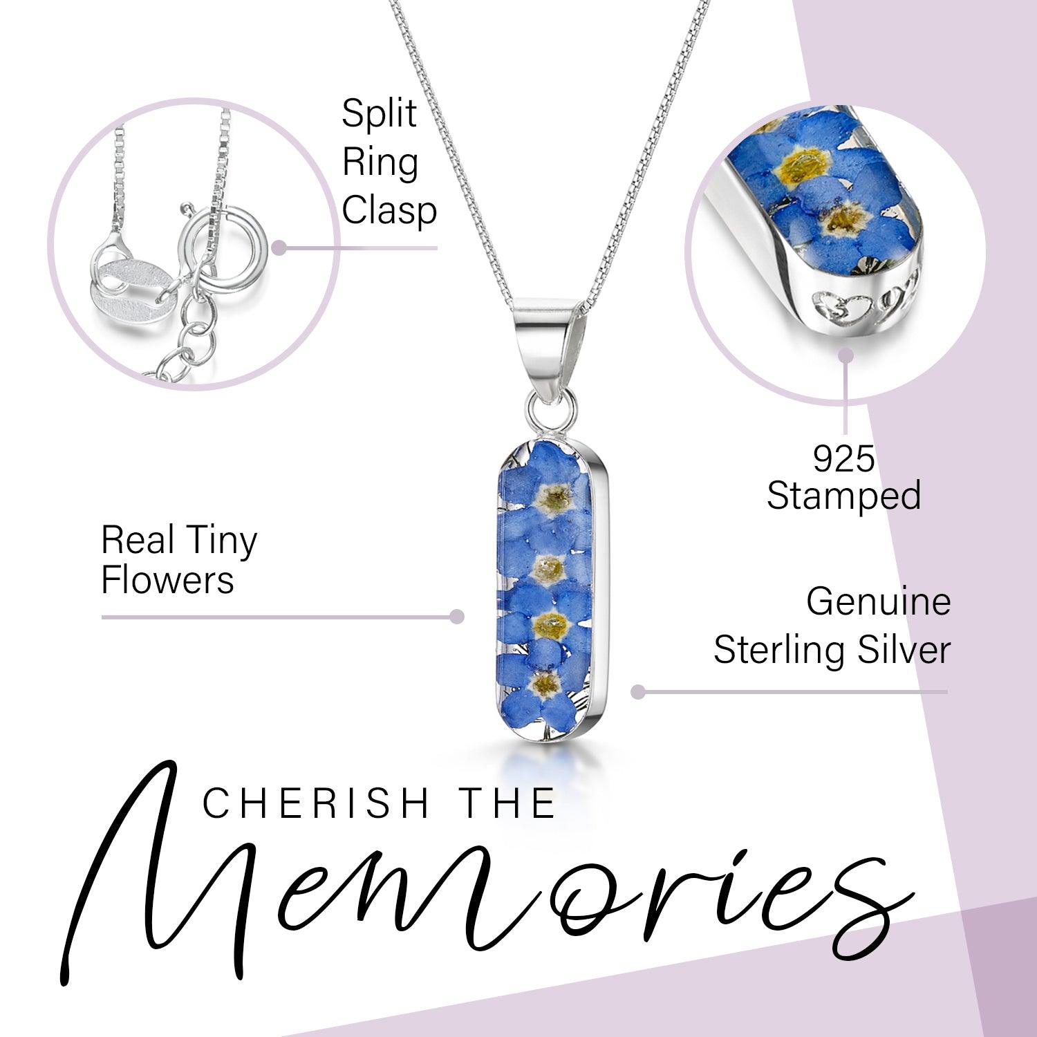 Forget Me Not necklace 'Leela' featuring a vertical bar pendant with real blue flowers encased in resin, on a sterling silver chain.
