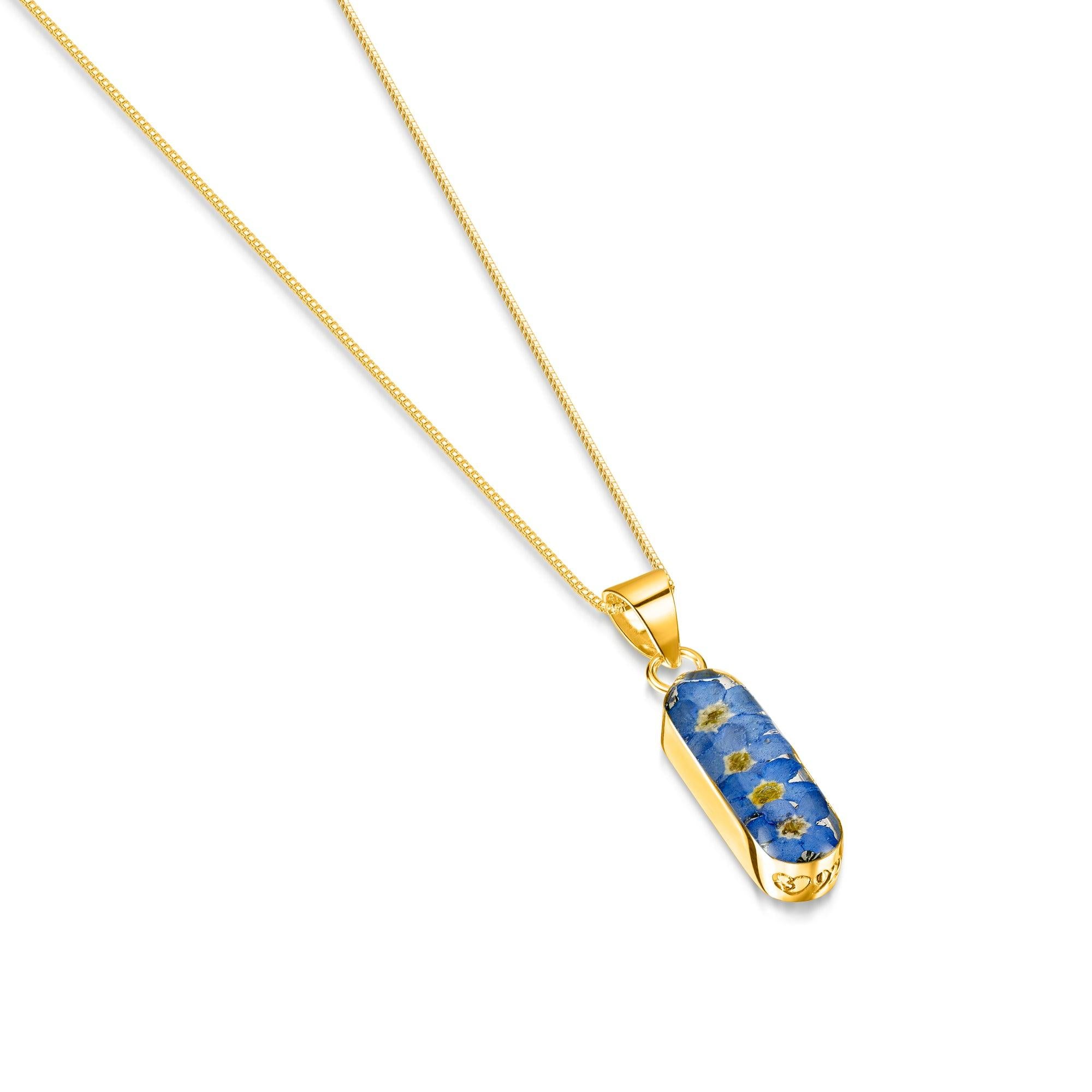 Forget Me Not necklace 'Leela' featuring a vertical bar pendant with real blue flowers encased in resin, on a sterling silver chain.