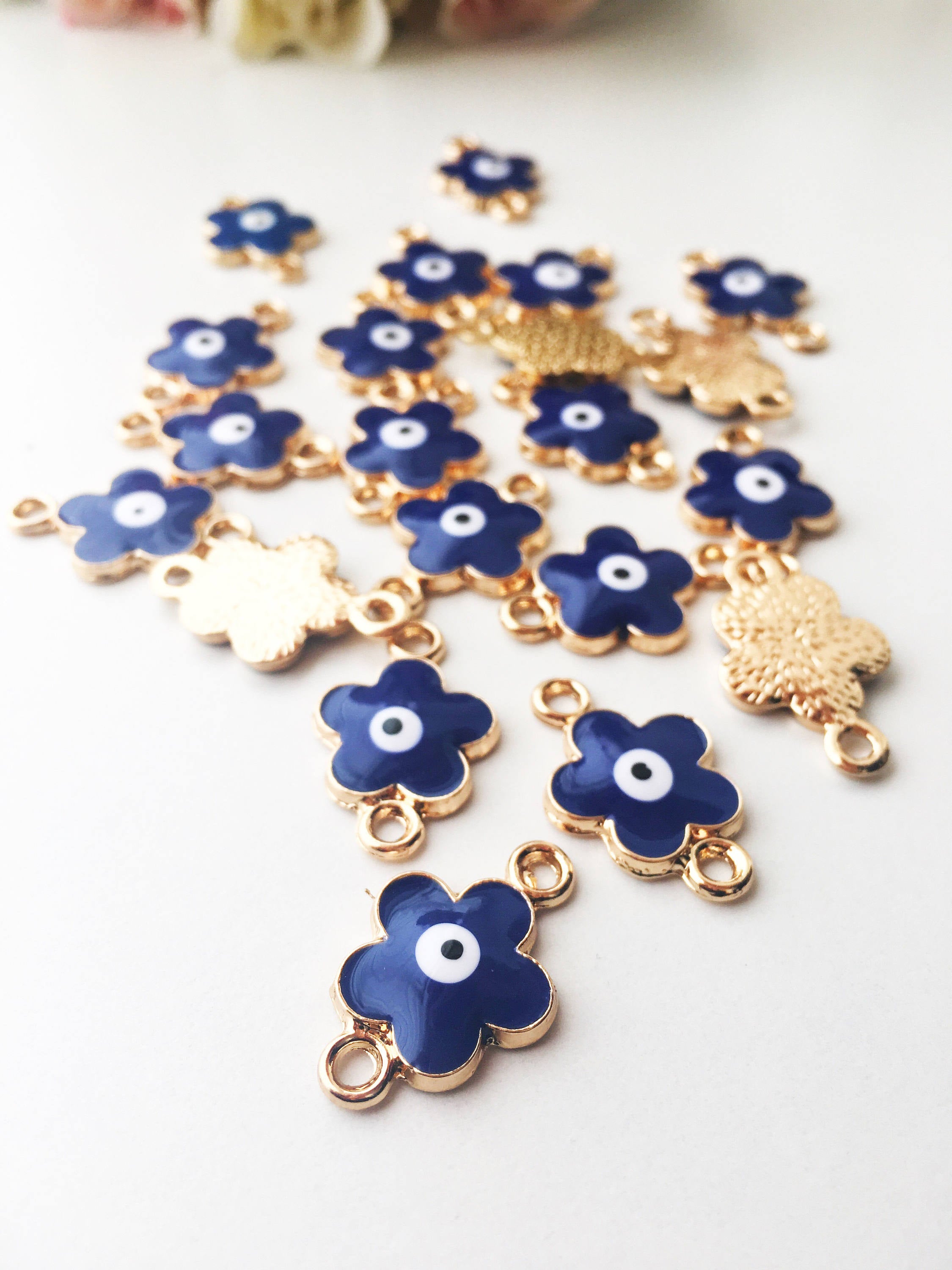 Five pieces of Four Leaf Clover Evil Eye Charms, gold plated with dual-sided design, perfect for jewelry making.