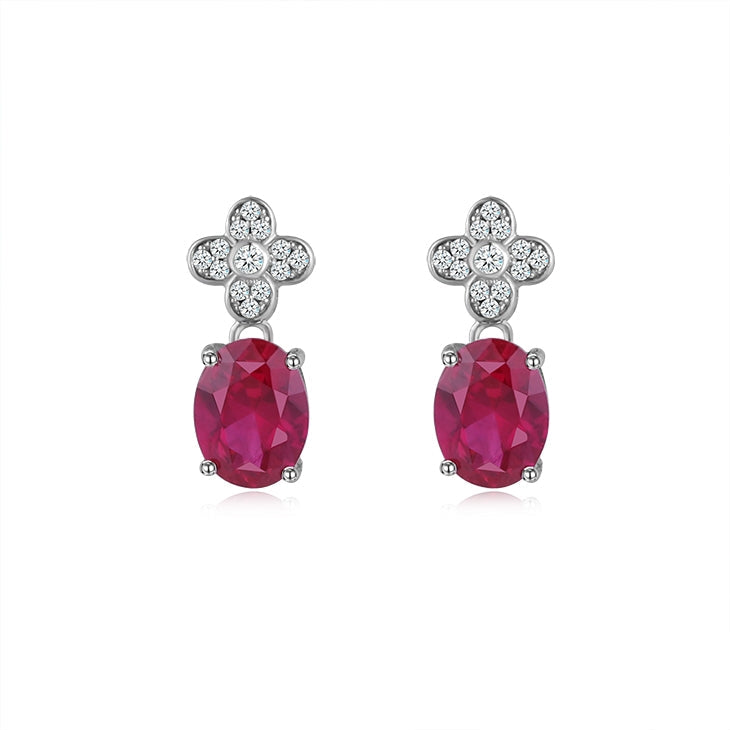 Elegant Four Leaf Clover Flower earrings made of 925 sterling silver, featuring white topaz and ruby stones, showcasing a unique design.