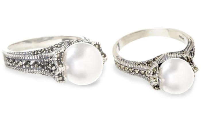 A stunning Freshwater Pearl and Genuine Marcasite Silver Ring featuring a round freshwater pearl surrounded by 49 marcasite stones set in sterling silver.