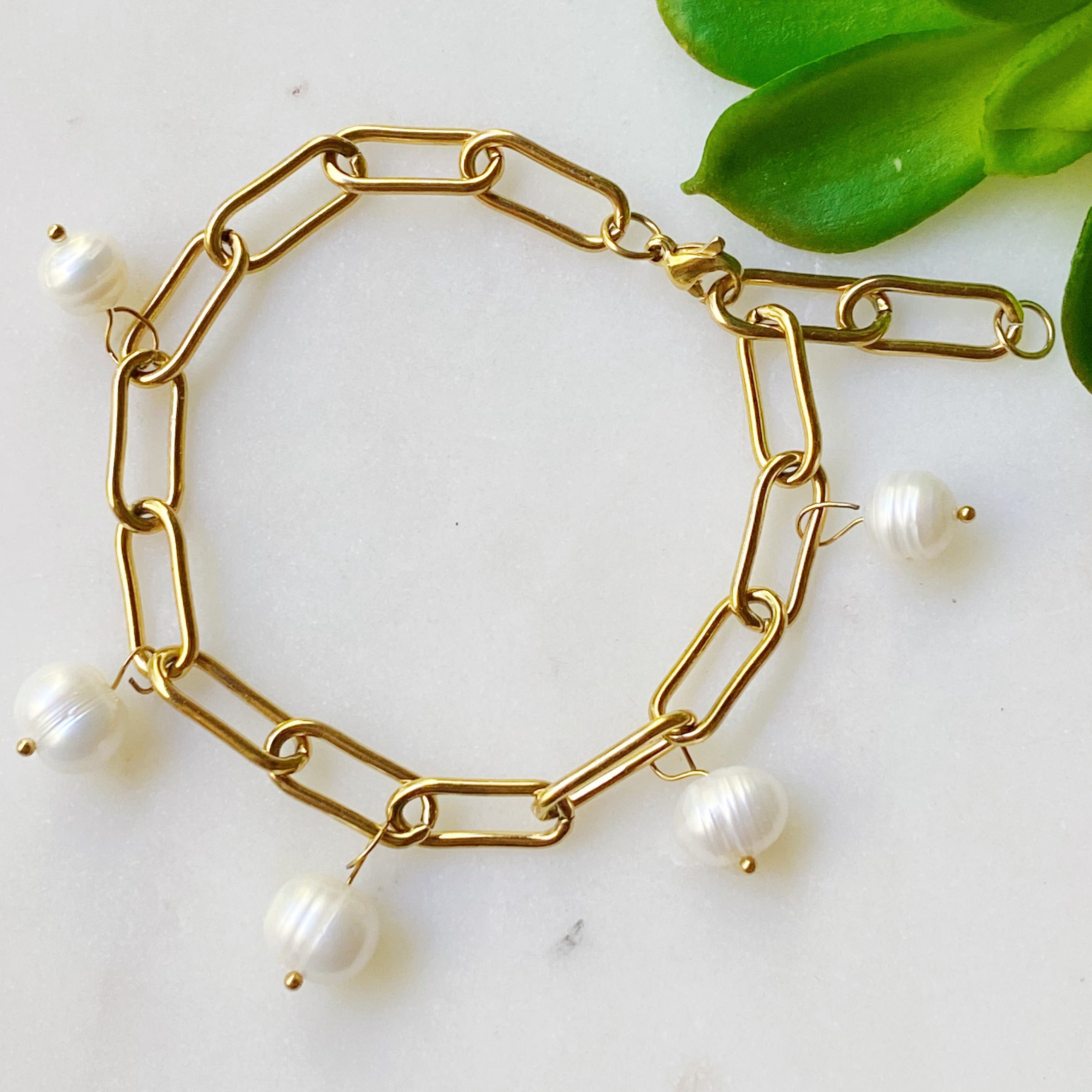 A beautiful Freshwater Pearl Chain Bracelet featuring delicate pearl charms on an adjustable gold-plated stainless steel chain.