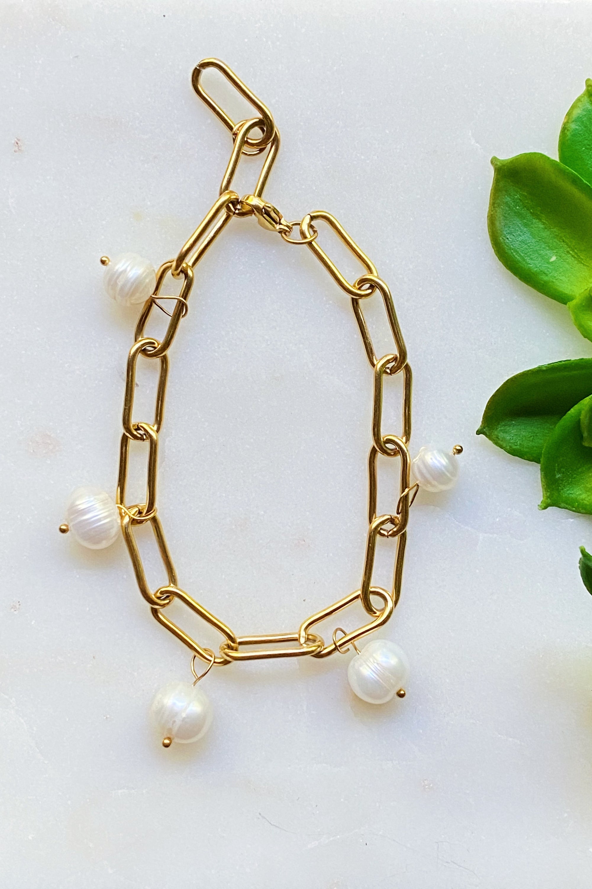A beautiful Freshwater Pearl Chain Bracelet featuring delicate pearl charms on an adjustable gold-plated stainless steel chain.