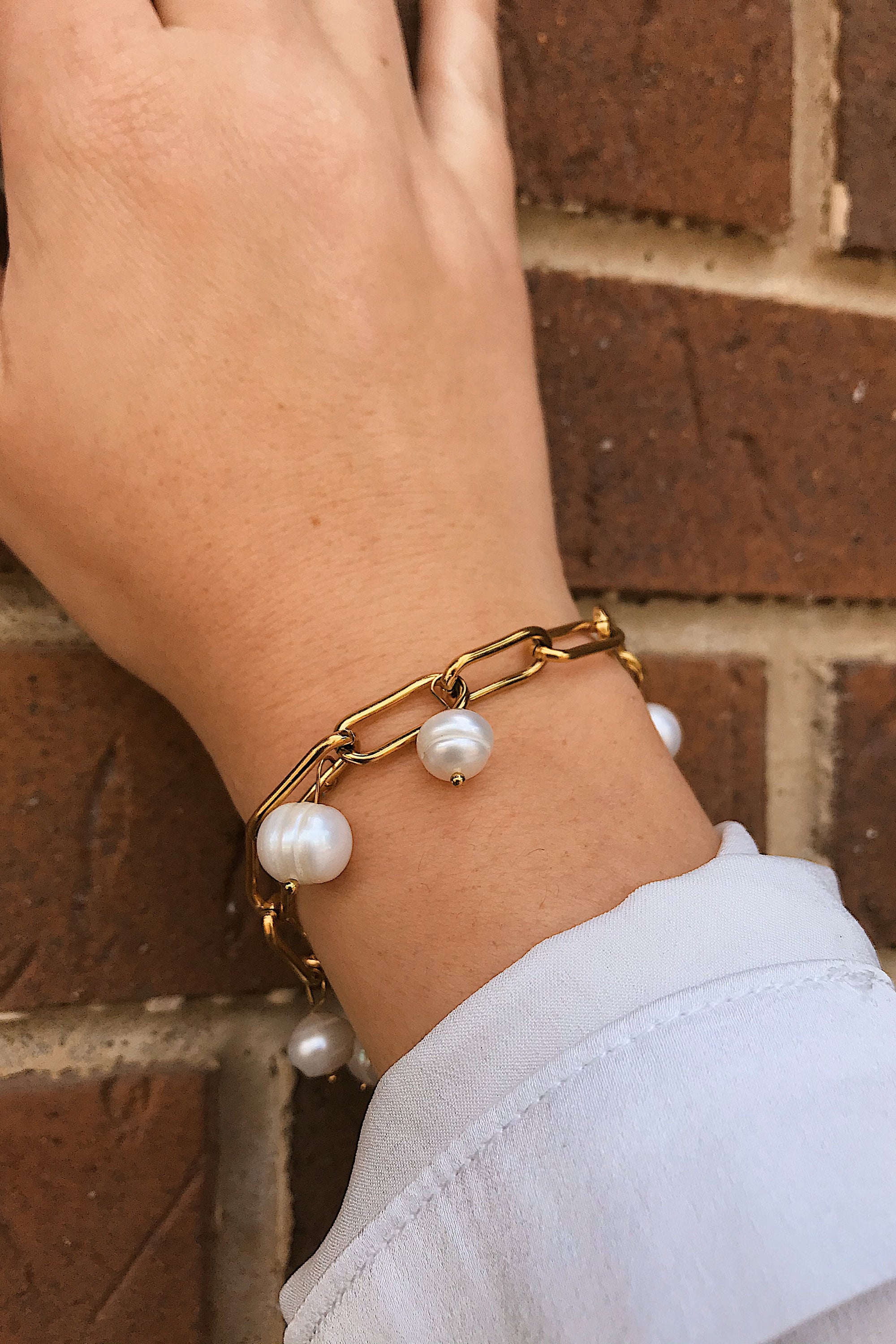 A beautiful Freshwater Pearl Chain Bracelet featuring delicate pearl charms on an adjustable gold-plated stainless steel chain.