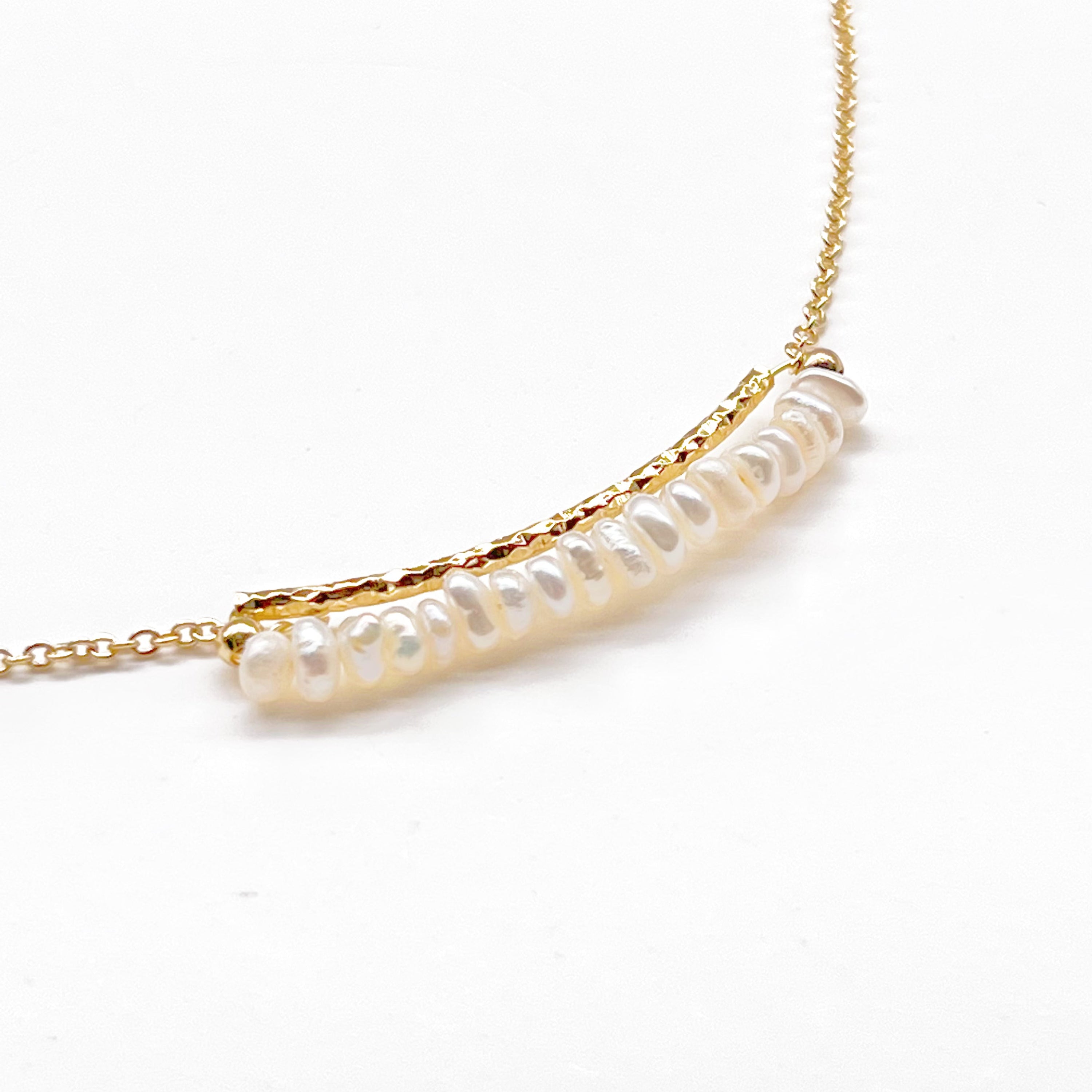 A delicate Freshwater Pearl Gold Bar Necklace featuring baroque pearls on a gold-plated chain, elegantly displayed in a gift box.
