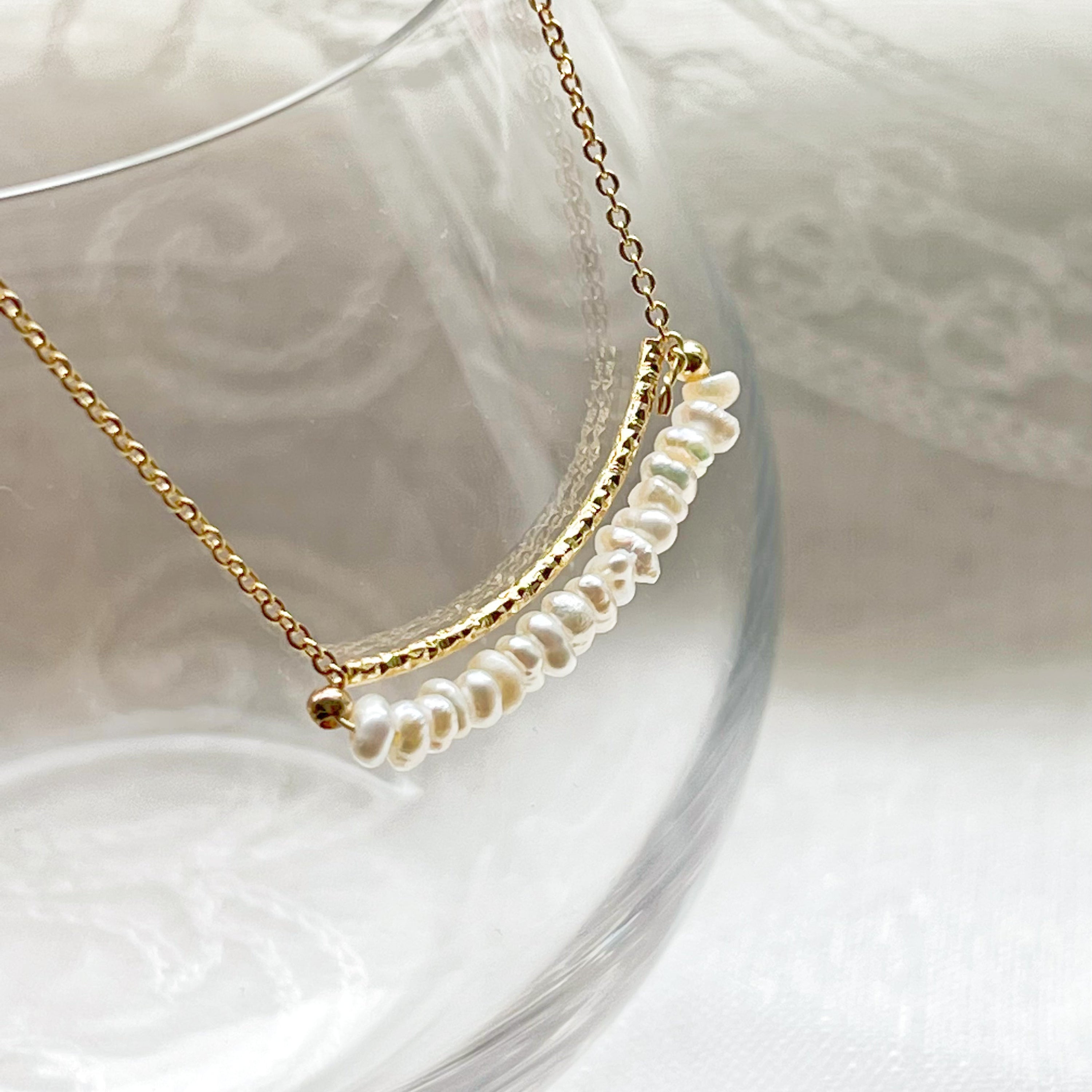 A delicate Freshwater Pearl Gold Bar Necklace featuring baroque pearls on a gold-plated chain, elegantly displayed in a gift box.