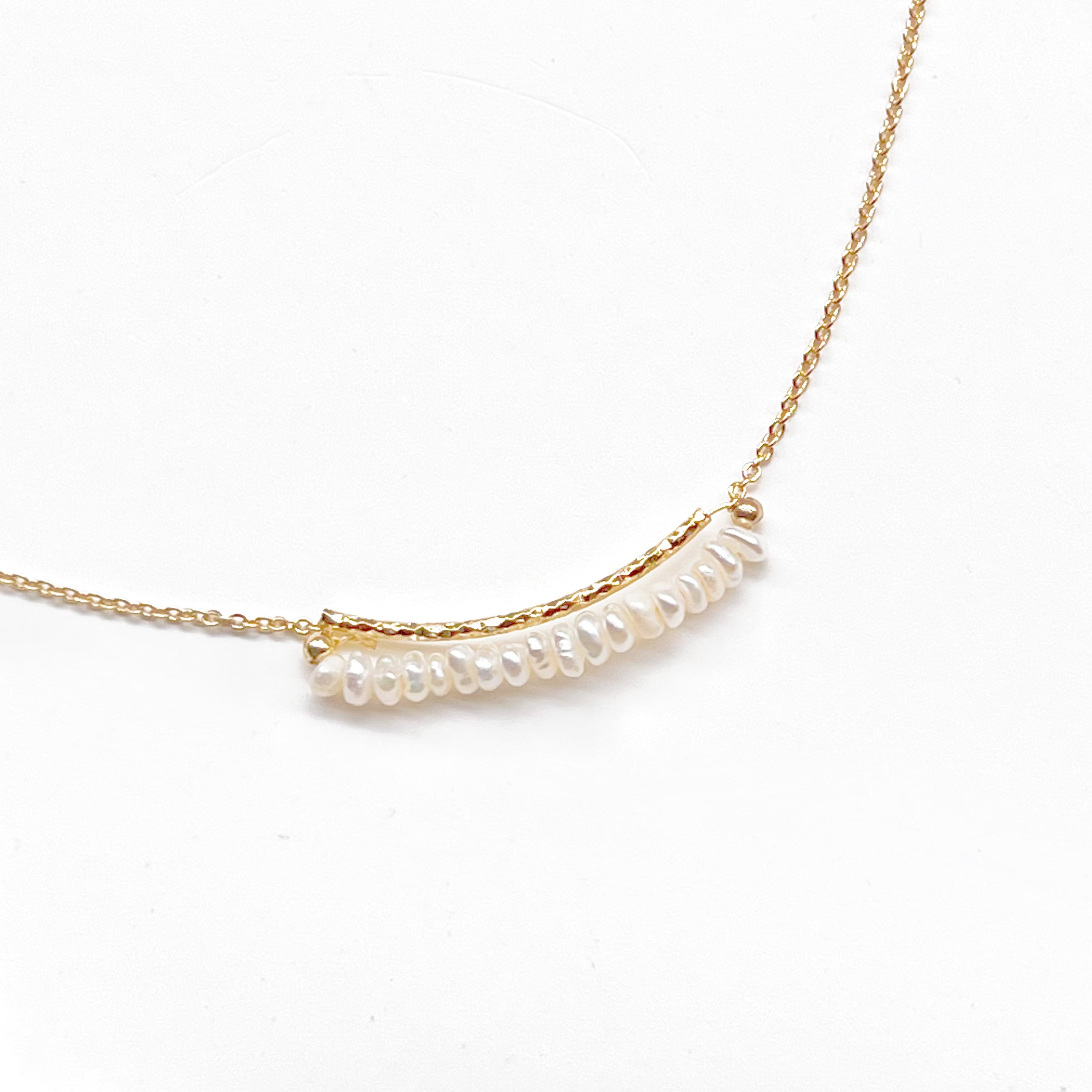 A delicate Freshwater Pearl Gold Bar Necklace featuring baroque pearls on a gold-plated chain, elegantly displayed in a gift box.