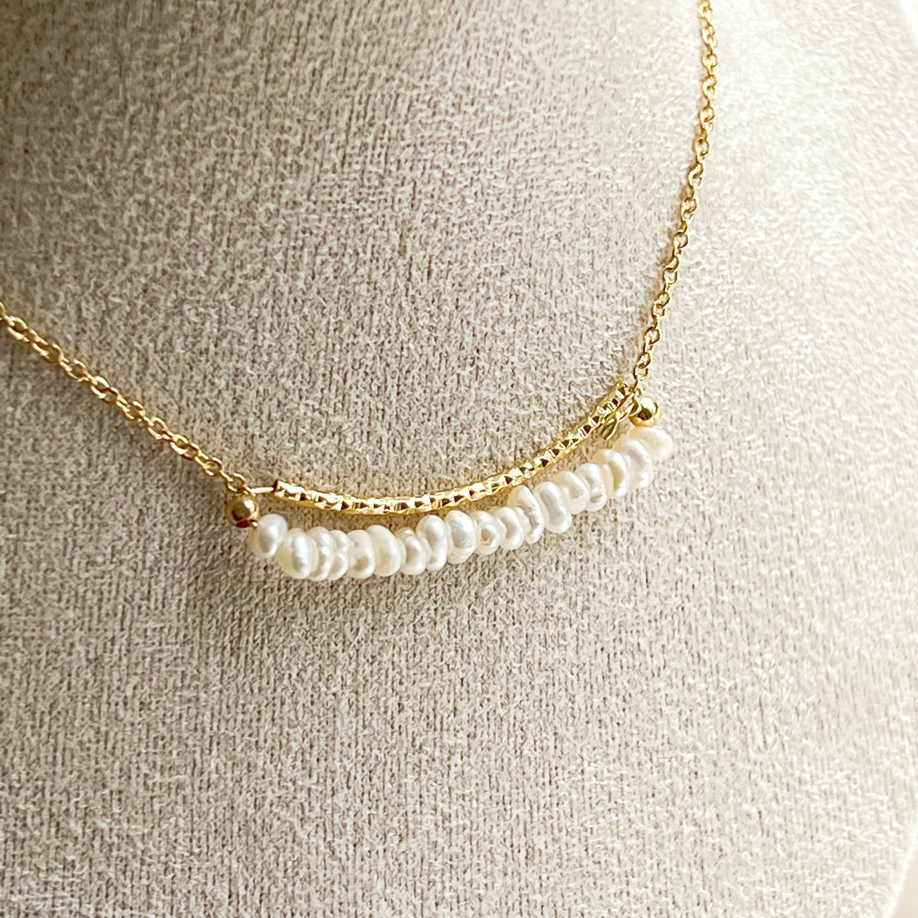 A delicate Freshwater Pearl Gold Bar Necklace featuring baroque pearls on a gold-plated chain, elegantly displayed in a gift box.