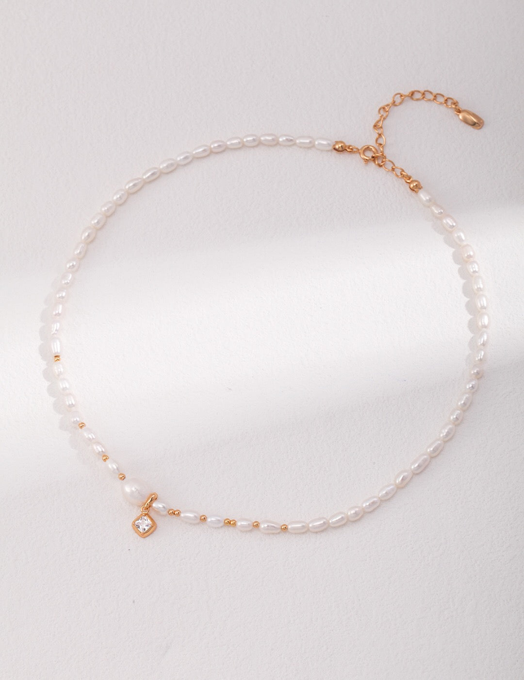 Elegant Freshwater Pearl Necklace with Gold Beads and Zircon Pendant, showcasing its luxurious design and craftsmanship.