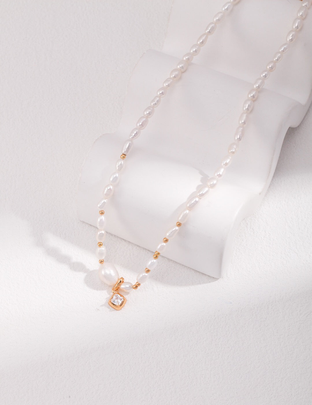 Elegant Freshwater Pearl Necklace with Gold Beads and Zircon Pendant, showcasing its luxurious design and craftsmanship.