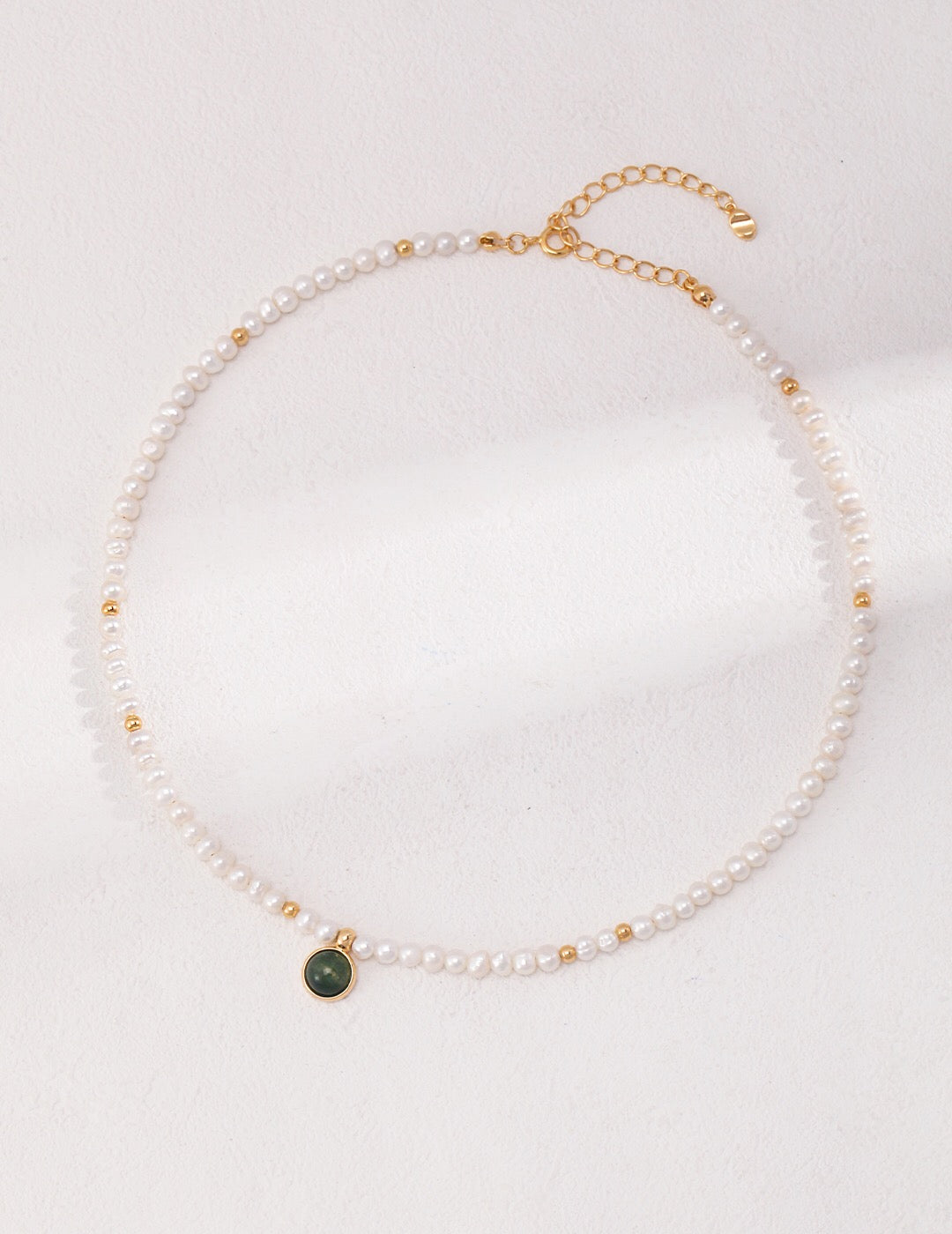 A beautifully handcrafted necklace featuring freshwater pearls and aquatic plant agate, accented with gold vermeil, showcasing elegance and natural beauty.