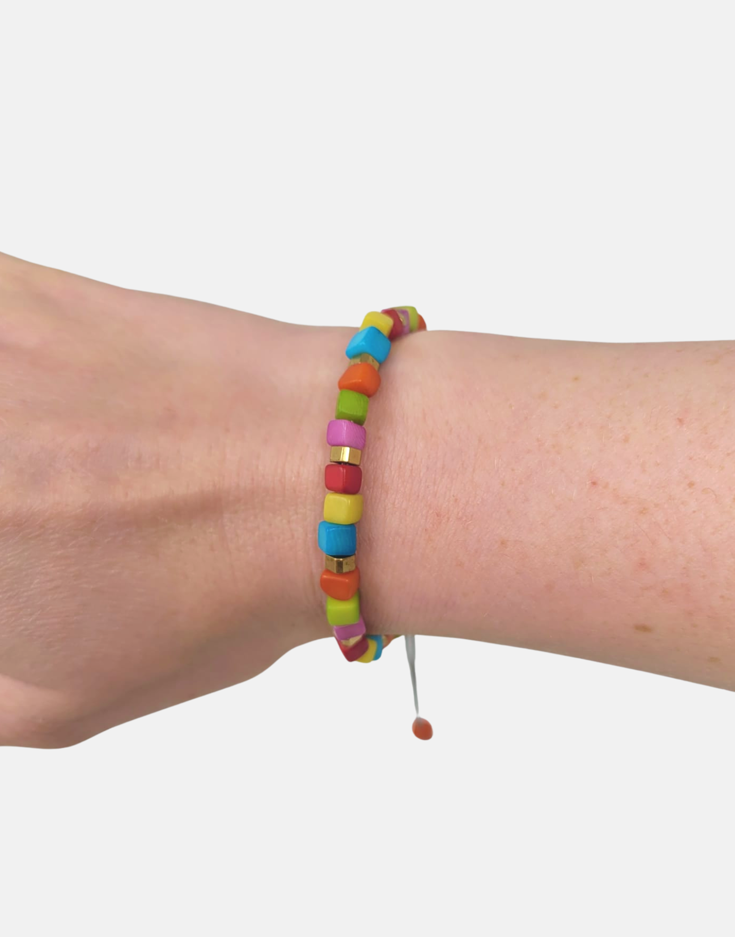 Friendship Tagua Bracelet made from tagua nut with raw brass details, showcasing its unique squares and adjustable fastener.