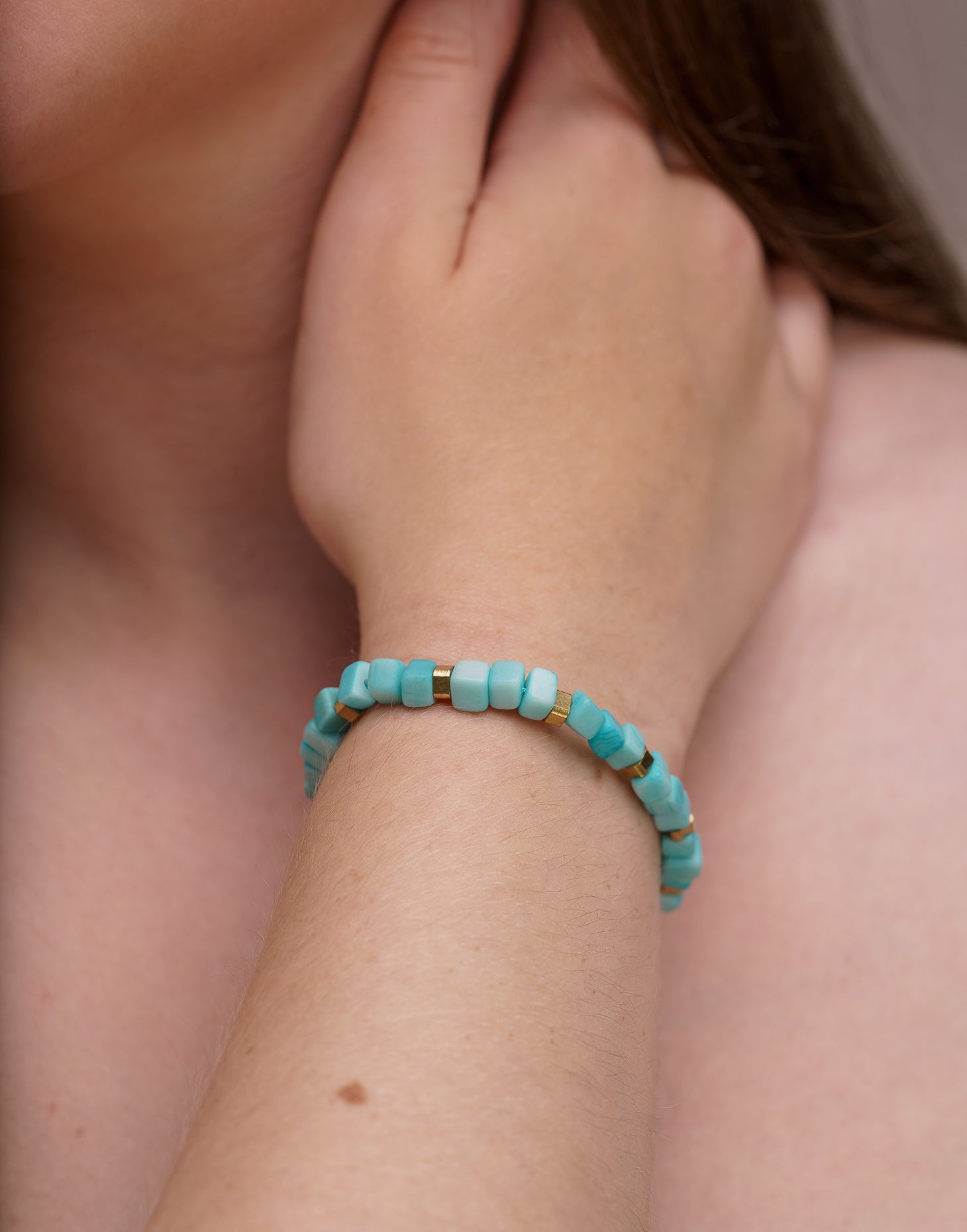 Friendship Tagua Bracelet made from tagua nut with raw brass details, showcasing its unique squares and adjustable fastener.