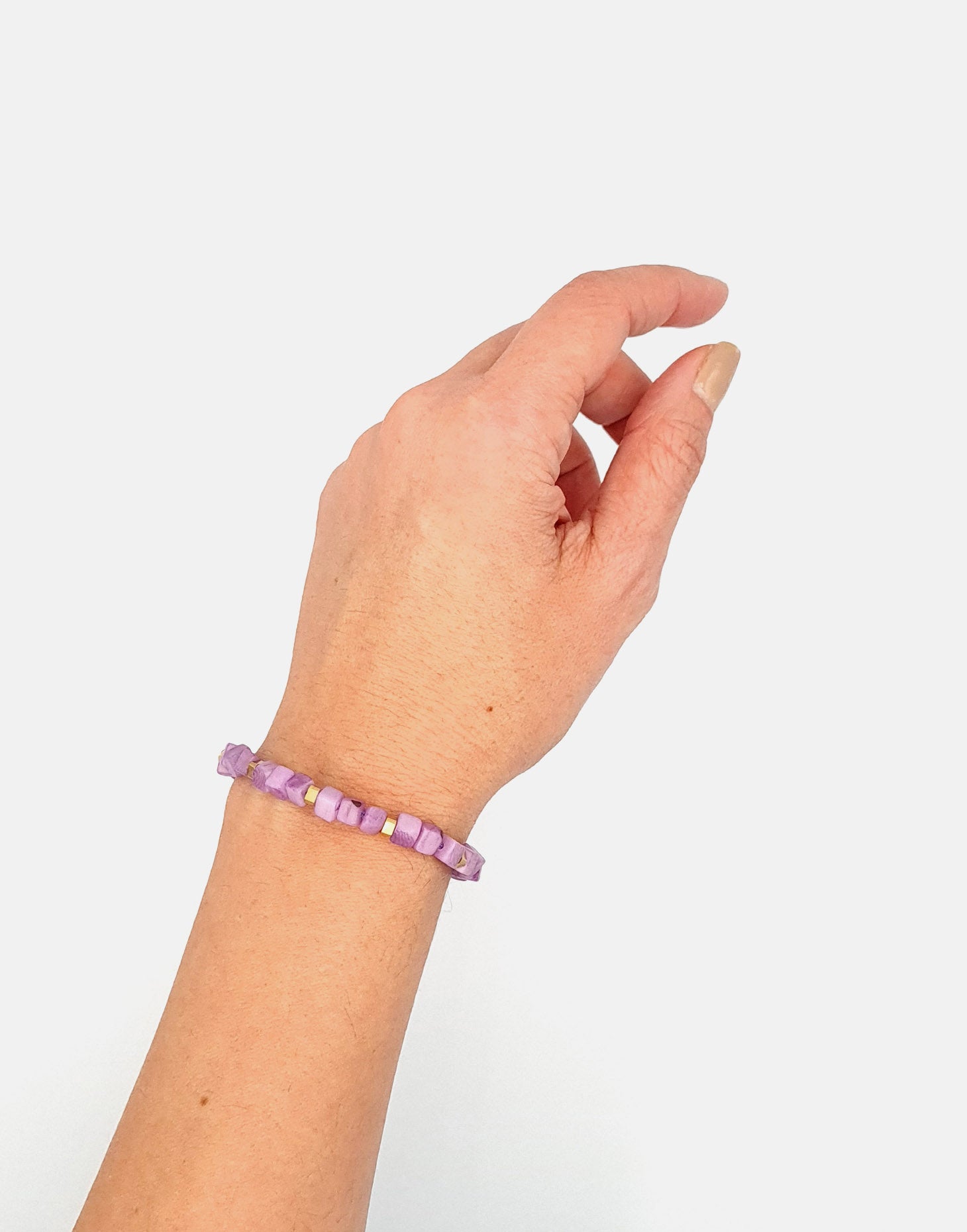 Friendship Tagua Bracelet made from tagua nut with raw brass details, showcasing its unique squares and adjustable fastener.