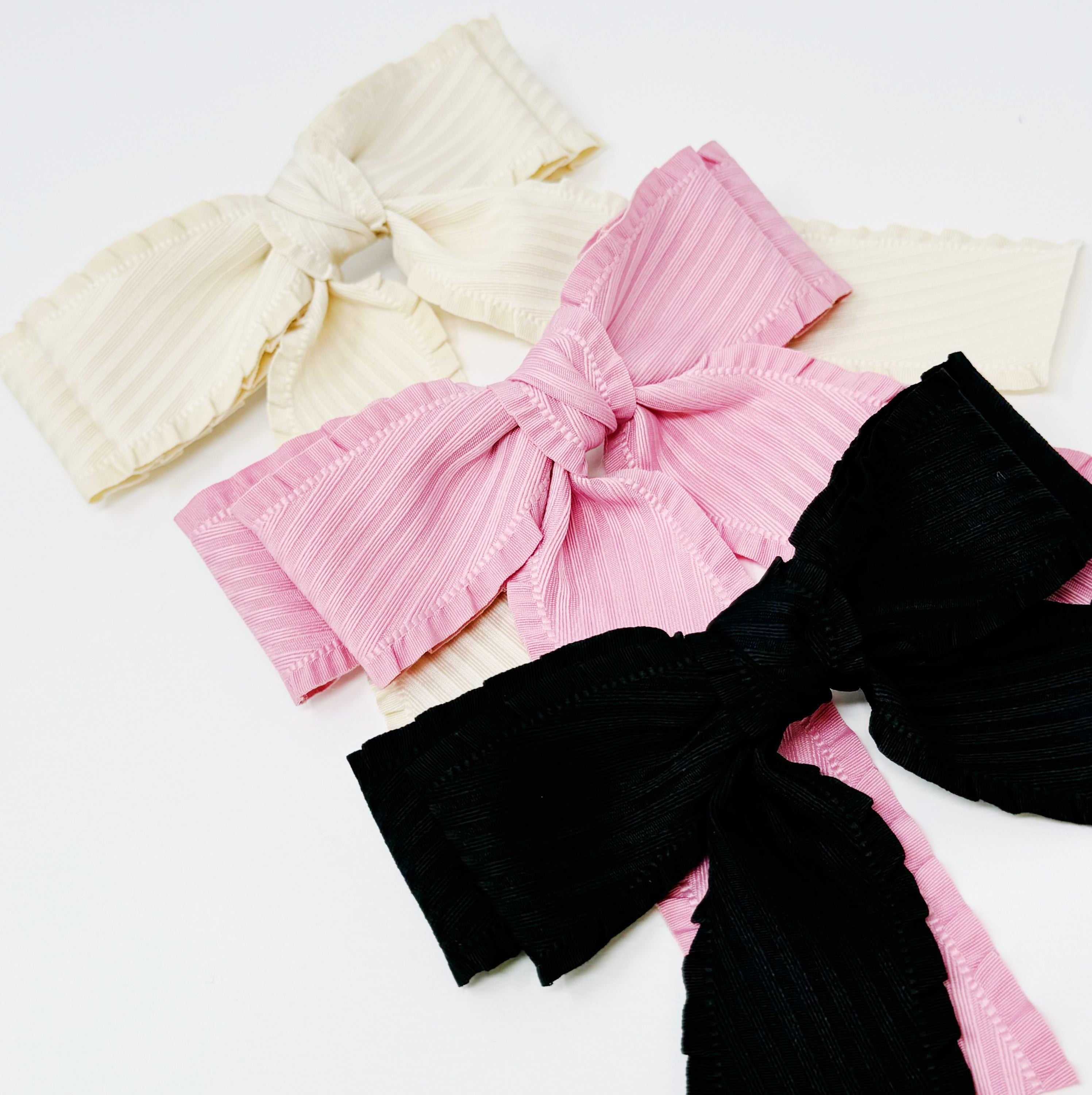 Frilled and Textured Doubled Bow Hair Clip in stylish design, featuring gentle frills and a structured fabric for a chic look.