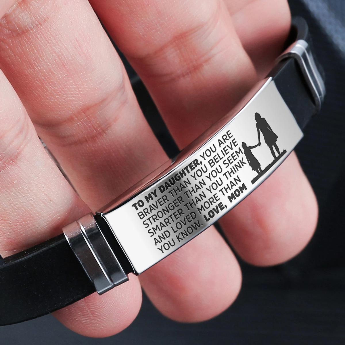 A beautiful steel and silicone bracelet engraved with a heartfelt message from mother to daughter, showcasing its elegant design and premium materials.